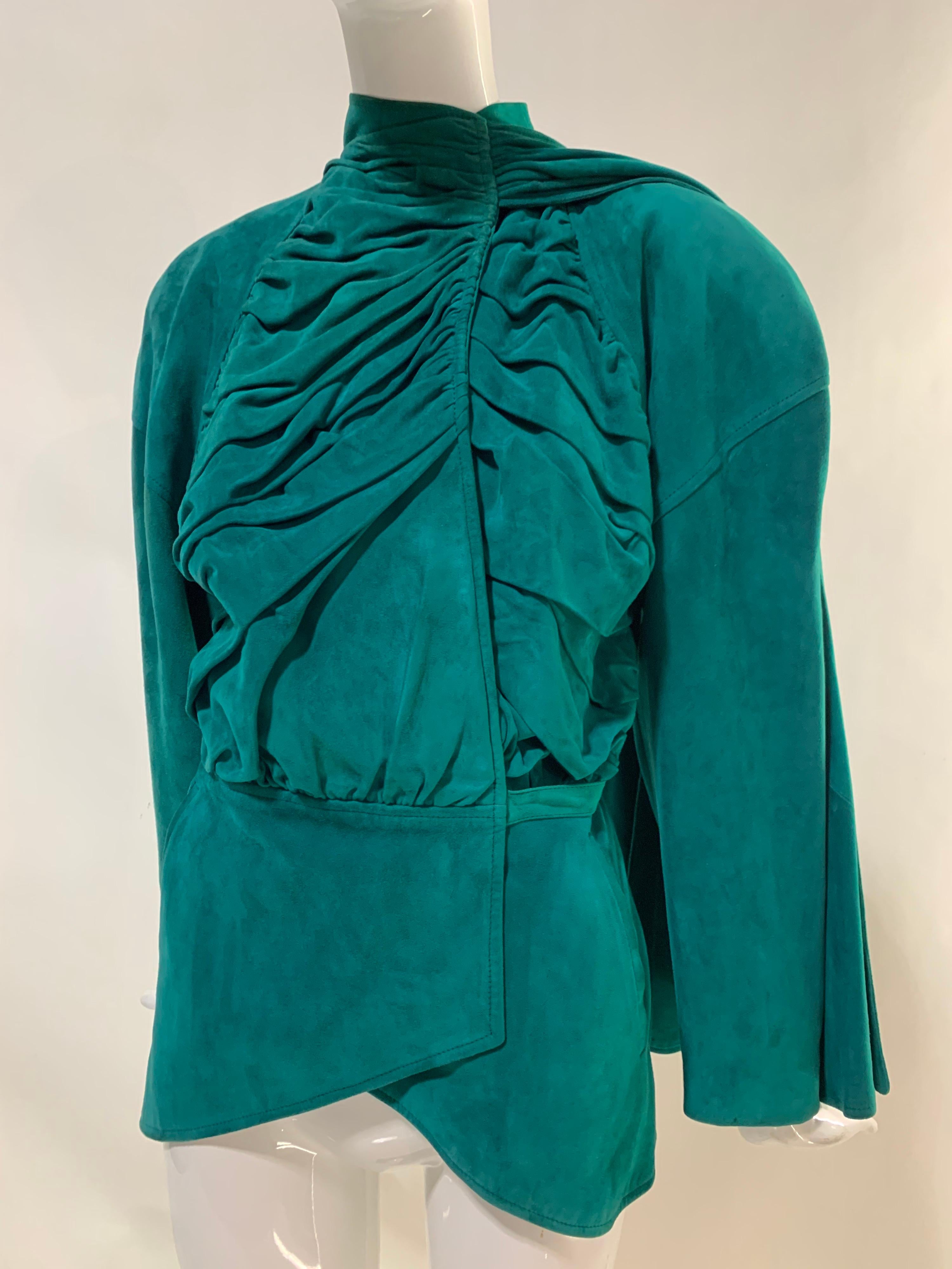 A striking 1980s Jean Claude Jitrois emerald green super-soft suede art-to-wear biker's jacket with asymmetrical ruched front, waist wrap-around tie and large suede foulard attached at one side to throw over the opposite shoulder. Instant attitude