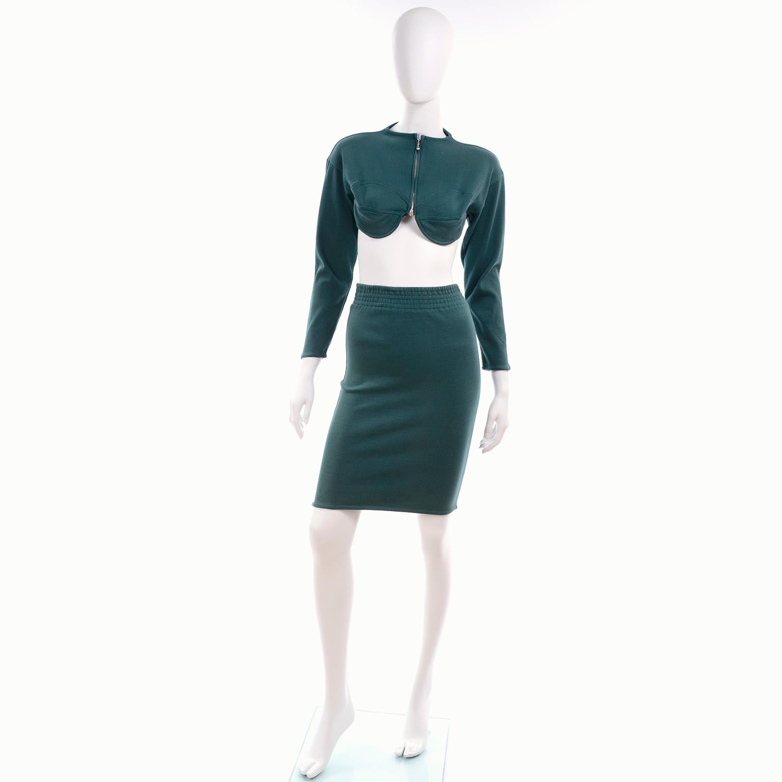 We absolutely adore this vintage late 1980's Jean Paul Gaultier Public outfit!  This two piece bare midriff ensemble is in a rich deep shade of green and is in an iconic Jean Paul Gaultier style.  This knit 2 pc dress includes a cropped bustier
