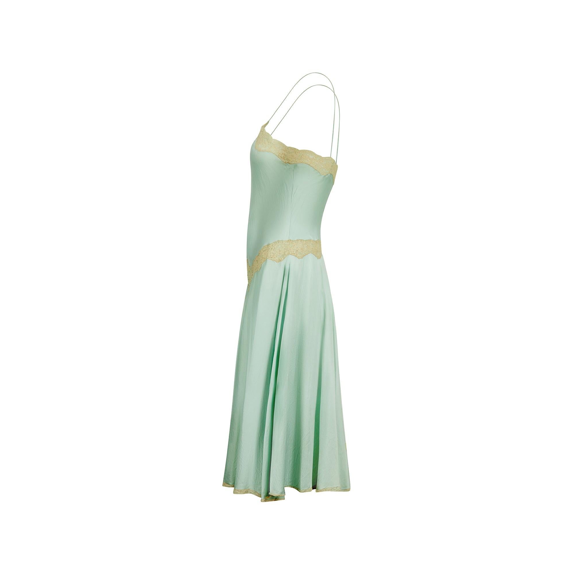 This elegant slip dress is cut from beautiful seafoam green silk and trimmed with pale off-white lace. Created by luxury lingerie label Jenny Dobell in the 1980s, it draws on classic 1920s’ silhouettes. The flared skirt kicks out as the wearer moves