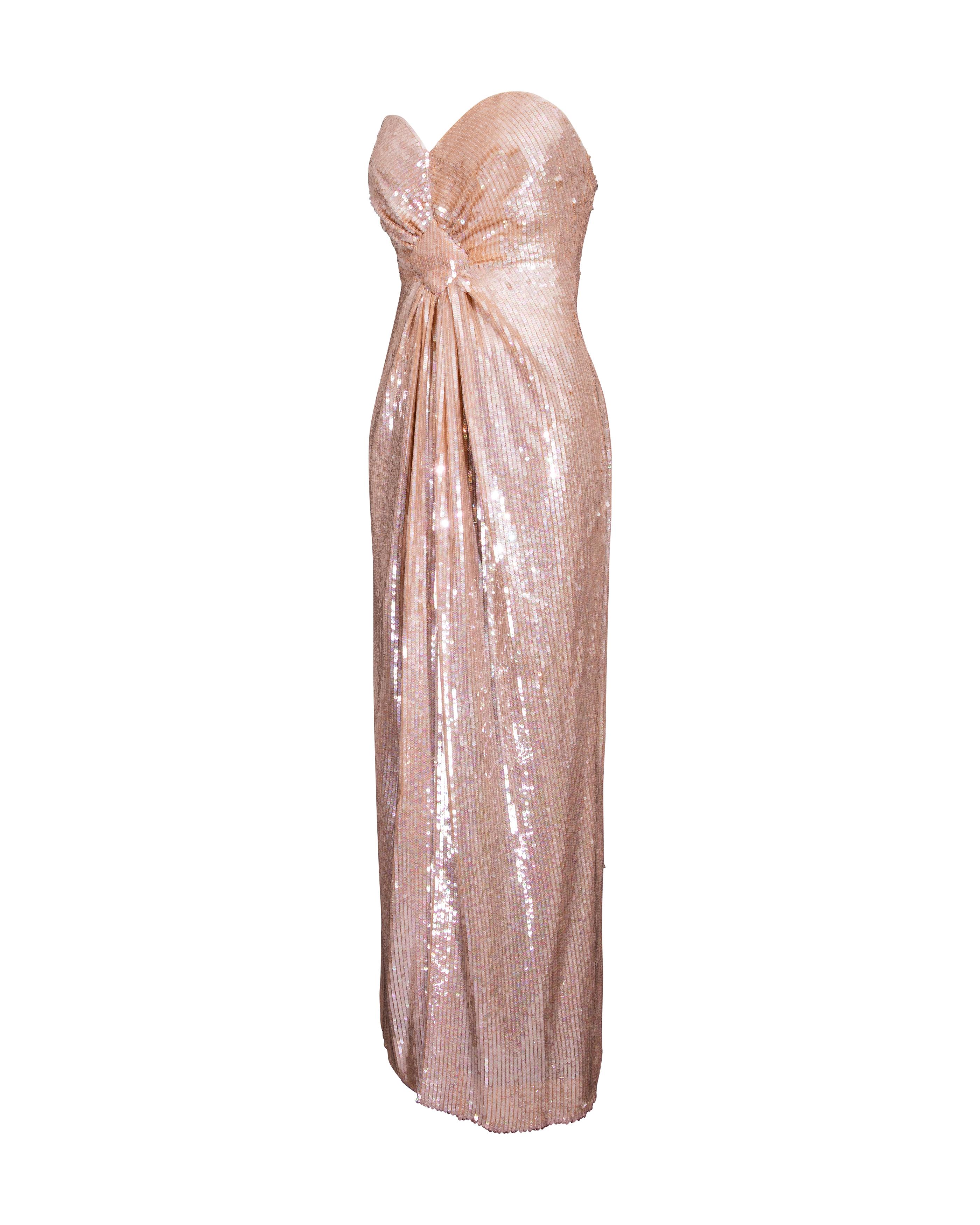 1980's John Anthony peach strapless fully sequined sheath gown with geometric center gathered detail. Built-in boning, waist belt and concealed back zip closure, with moderate length front slit. Fully lined with tan Rayon lining. In very good