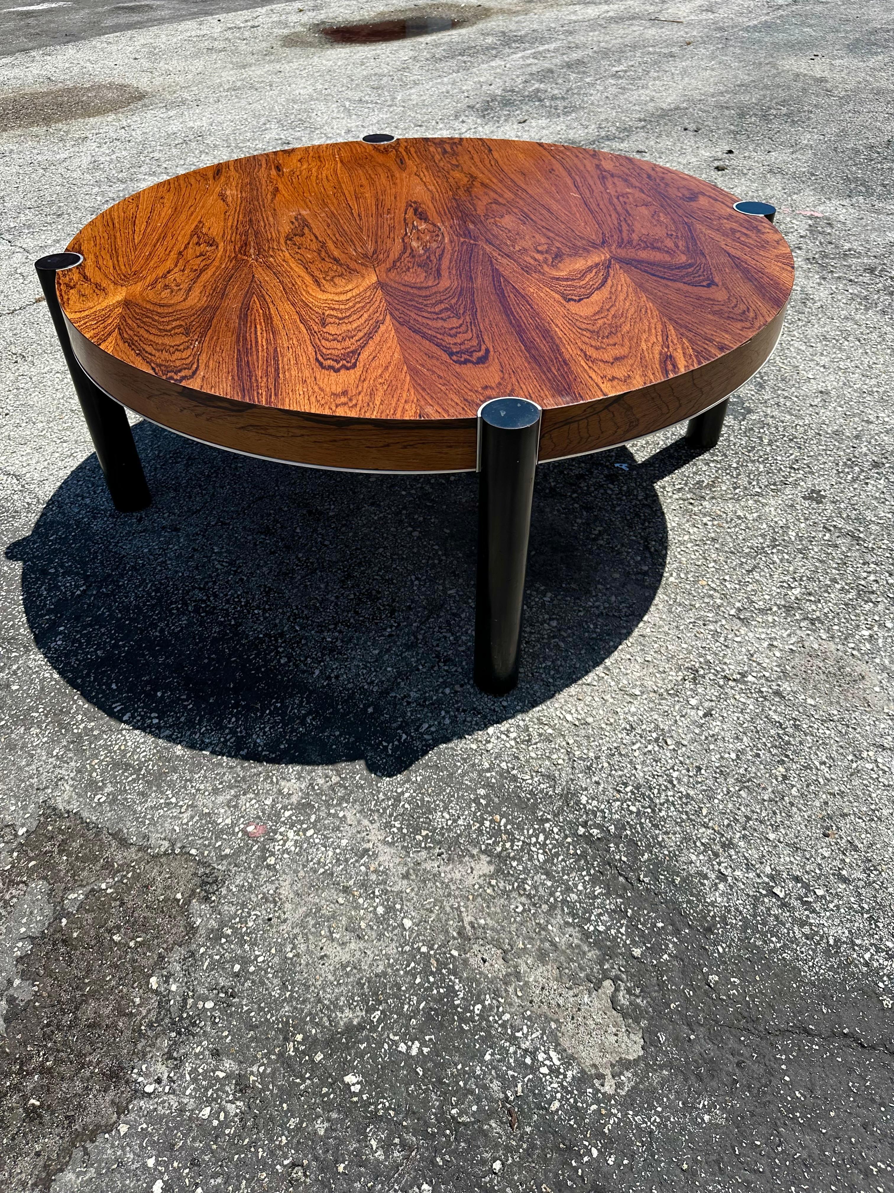 On offer on this occasion is one of the most stunning and rare, rosewood veneer with chrome trim round coffee table you could hope to find. In its original condition. No restoration. Outstanding design is exhibited throughout. The beautiful table is