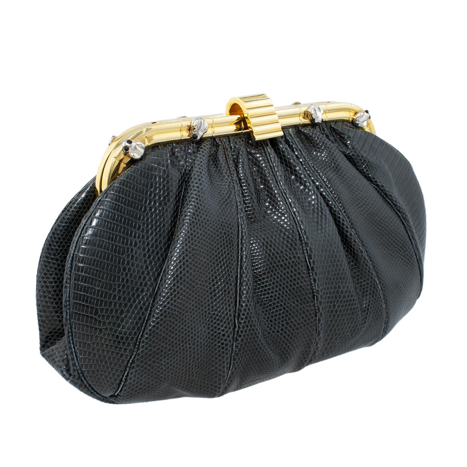 Very fun Judith Leiber evening clutch from the 1980s. Frame shape with a dark grey reptile and gold tone metal hardware that is embellished with small silver tone metal frogs with black eyes. Optional 20