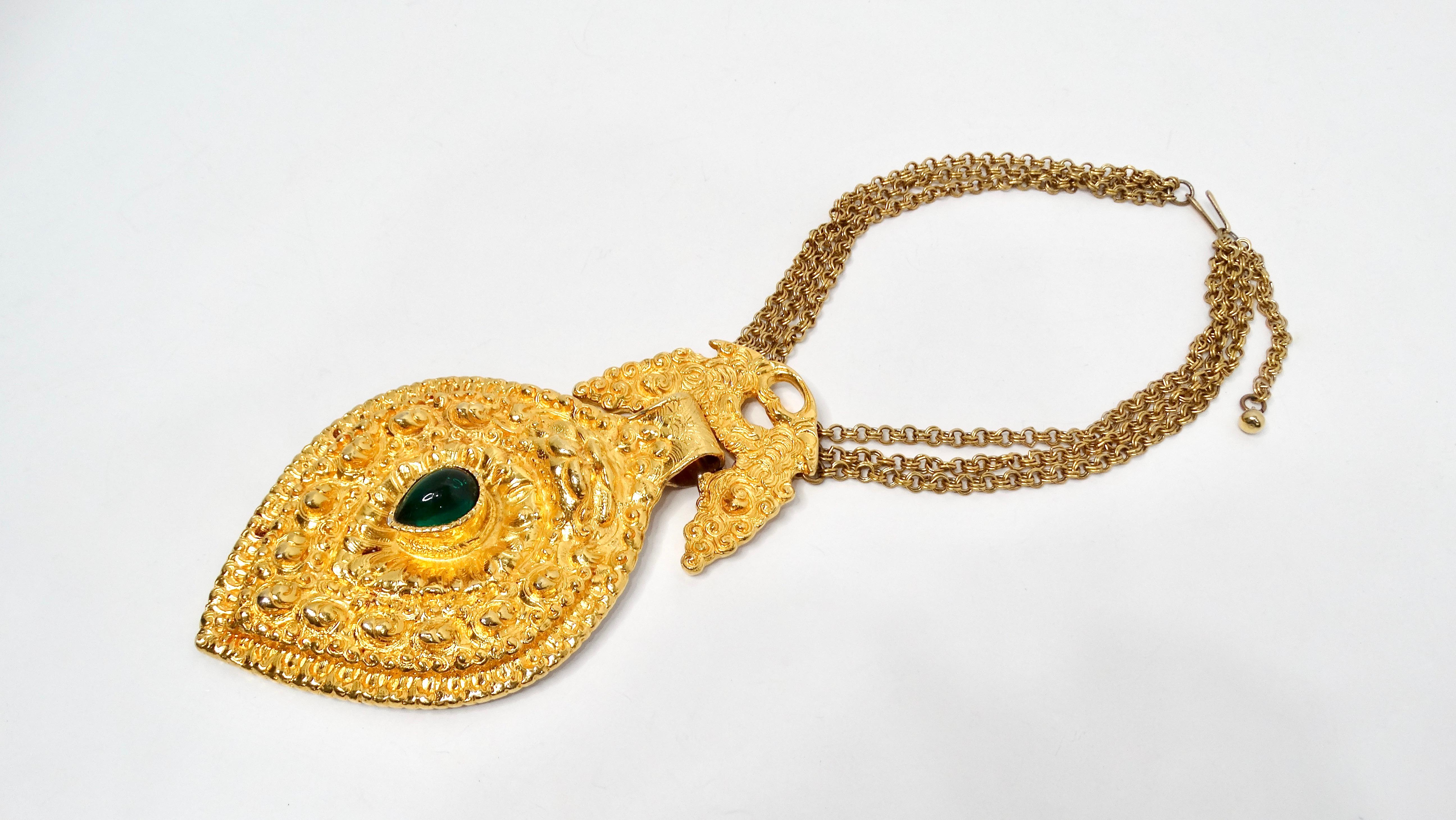 The 1980s Judith Leiber Large Egyptian Style Gold-Tone Pendant Necklace is an exquisite example of vintage costume jewelry that effortlessly combines opulence with artistry. This statement piece features a striking gold-tone rope chain adorned with