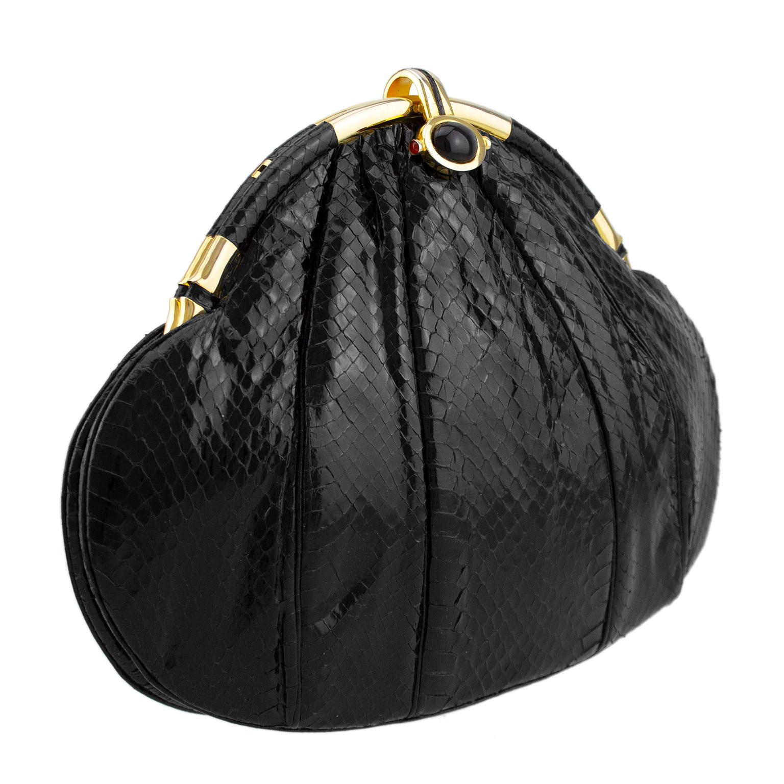 Judith Leiber large art deco style evening clutch from the late 1980s. Black imprinted simulated reptile with gathering and pleats that add texture. Contrasting gold tone metal hardware and a large oval cabochon at closure. Black satin interior with