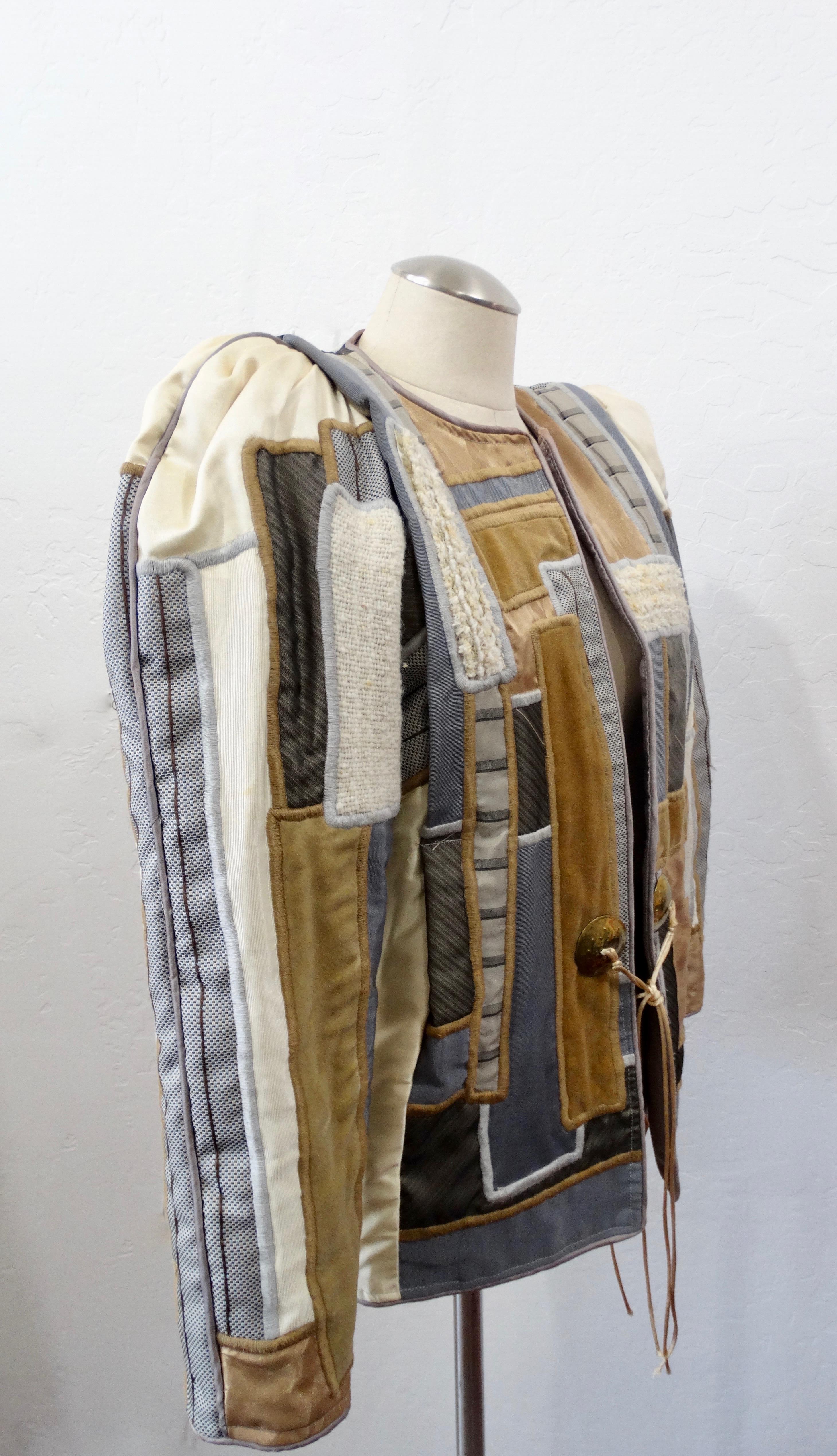 The Most Unique Jacket Is Here! Circa 1980s, this Judith Roberts jacket features amazing appliqué patchwork made up of abstract designs in a mixture of soft colors and a variety of beautiful textured fabrics. Includes large gold toned buttons with