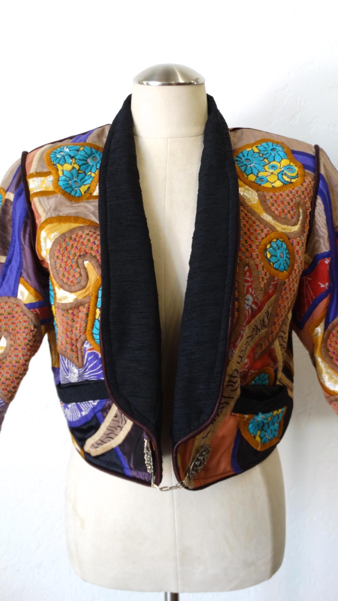 The Most Unique Jacket Is Here! Circa 1980s, this Judith Roberts jacket features amazing appliqué patchwork made up of abstract designs in bright and warm colors, and a variety of beautiful fabrics. Includes large silver buttons with abstract