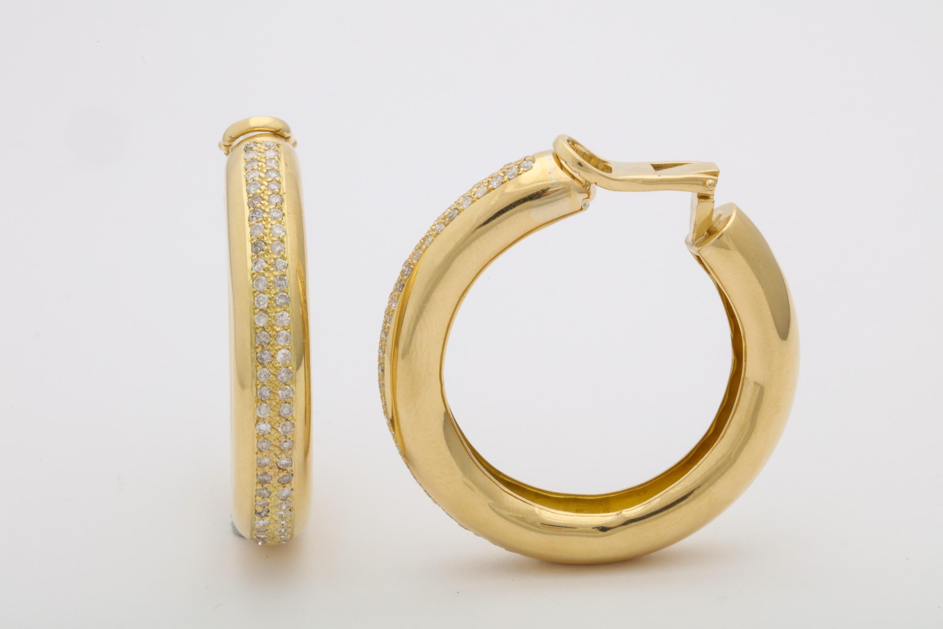 One Pair Of Large Ladies 18kt Gold Jumbo Hoop Earrings Designed With A Double Row Of Diamonds Totaling Approximately 3 Carats. One Minor Dent To Side Of Earrings Barely Noticeable To Naked eye. High Quality Clip On Backs In Which Posts May Be Added