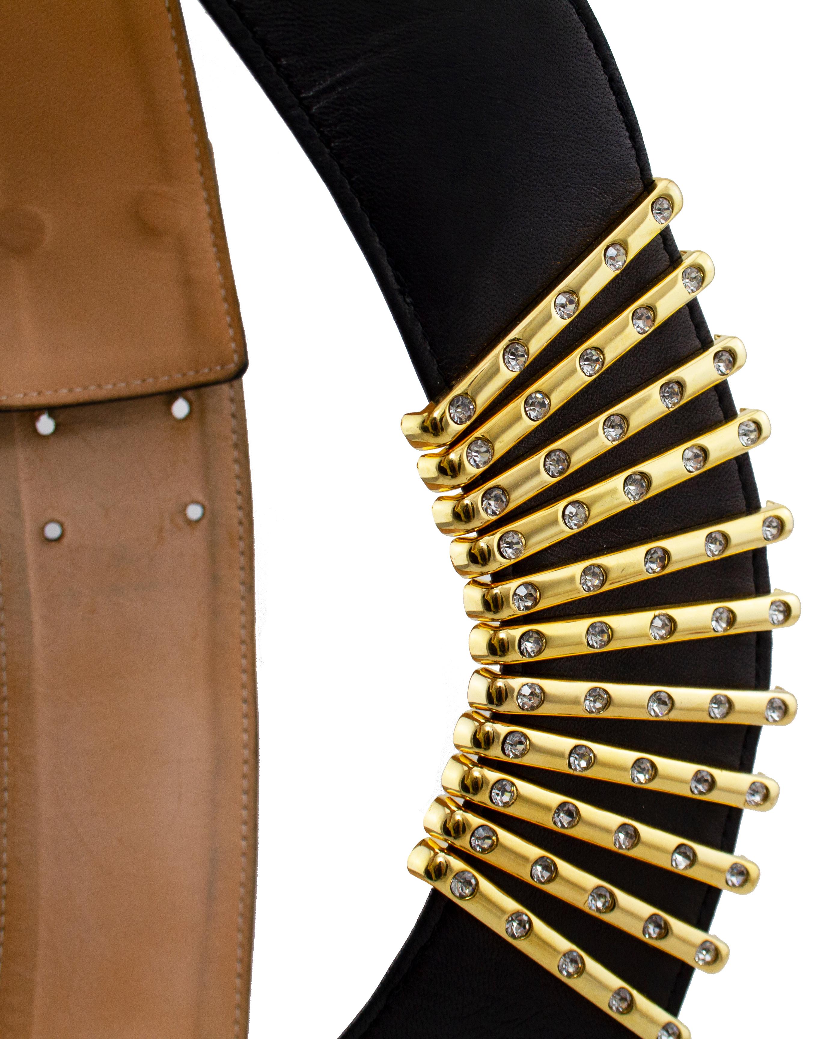 Fabulous 1980s statement piece belt by Karl Lagerfeld. Black supple leather with contrasting gold metal and rhinestone bar details at centre front. Sits at the waist and the front dips lower in a very flattering way. Beige leather interior with
