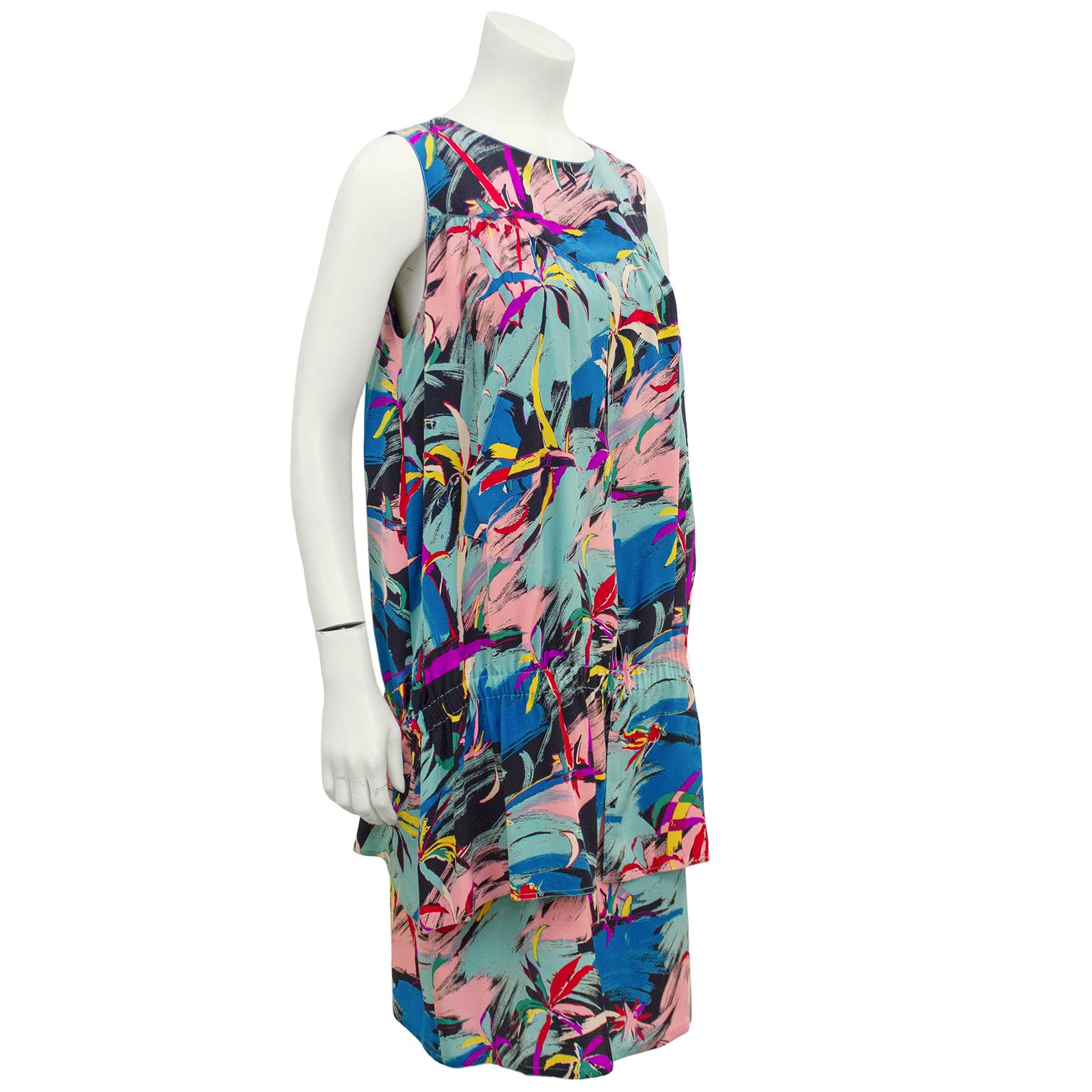 Interesting Karl Lagerfeld abstract brush stroke, tropical print dress from the 1980s. Mix of bright and pastel colours. Slated pocket details at waist. Sleeveless, drop elastic waist and tiered hem. Excellent vintage condition. Fits like a US 6. 