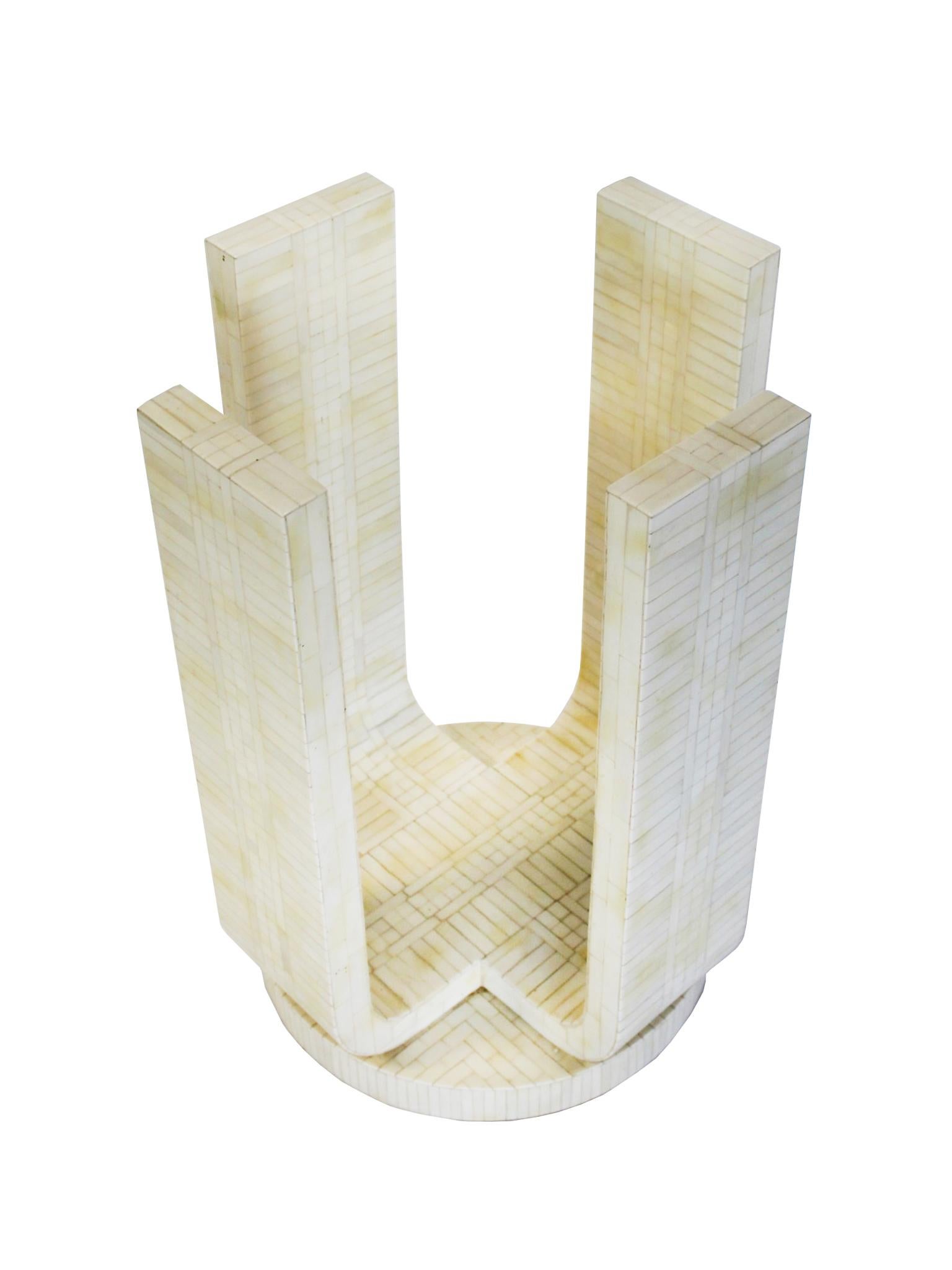 This 1980s center table shares a sensibility with Karl Springer's creations - designs that often utilized unconventional materials like bone and shagreen. This table features tessellated bone intricately arranged on the surface of the pedestal base.