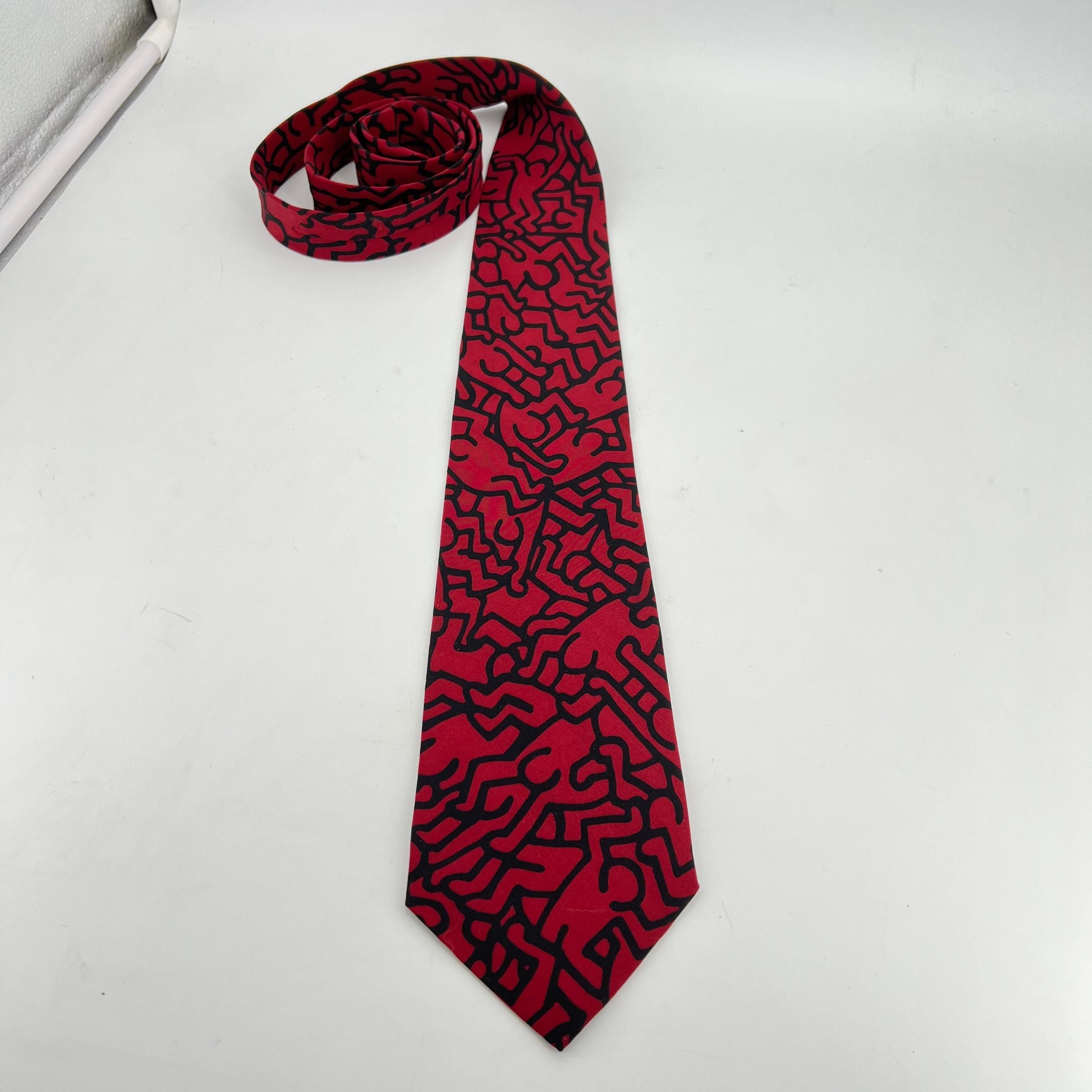 A limited edition Black and Burgundy silk tie created from a commissioned design by Keith Haring for Playboy Magazine in 1986. Without issues, the colors are burgundy and black, both vibrant. Length is 59 inches, and the widest width is 3.75