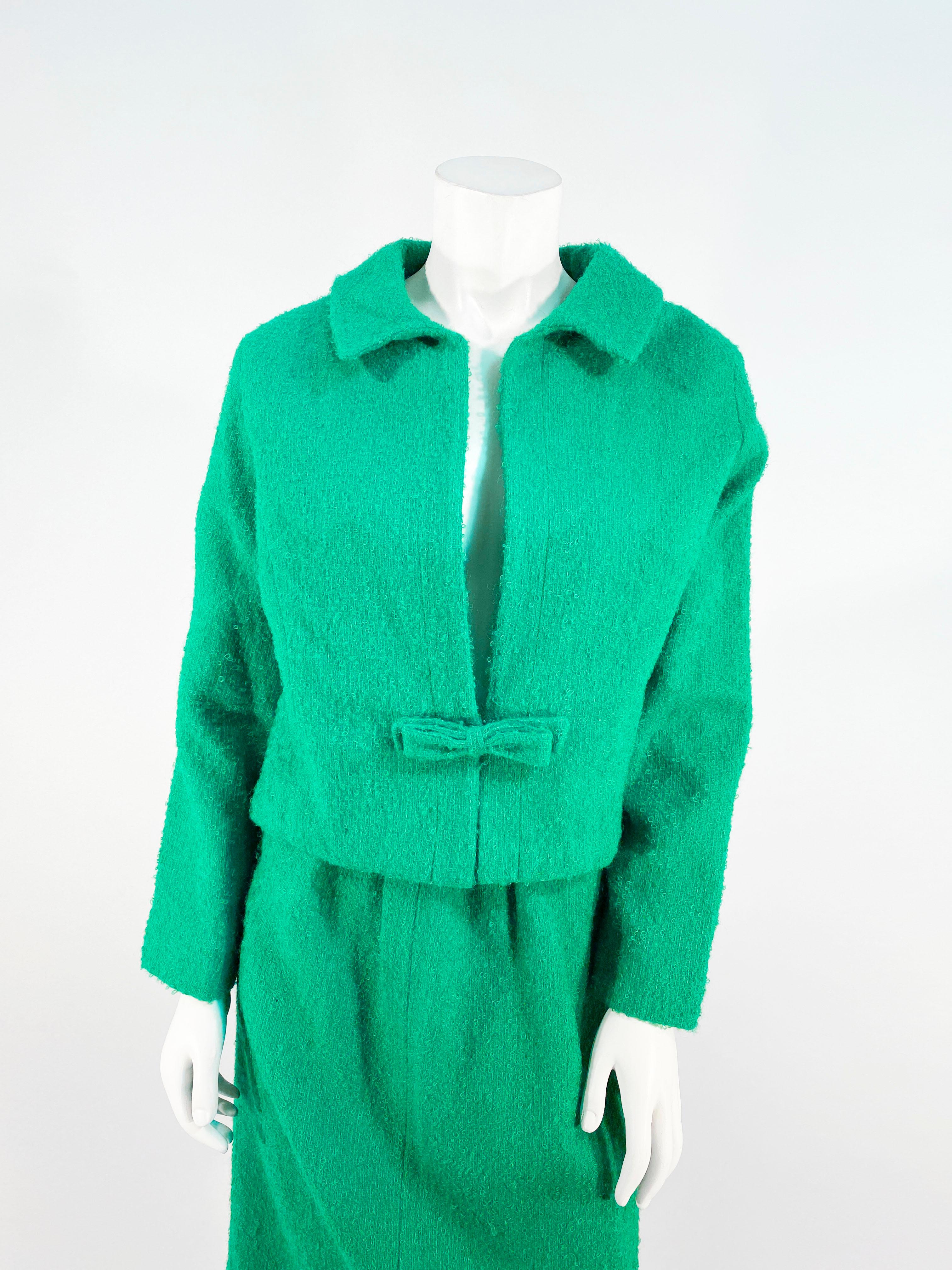 1980s Saks Fifth Ave. kelly green mohair suit with a boxed style jacket with full length sleeves, interior lining, and a bow closure that creates a plunging neckline. The straight skirt has an applied waistline.