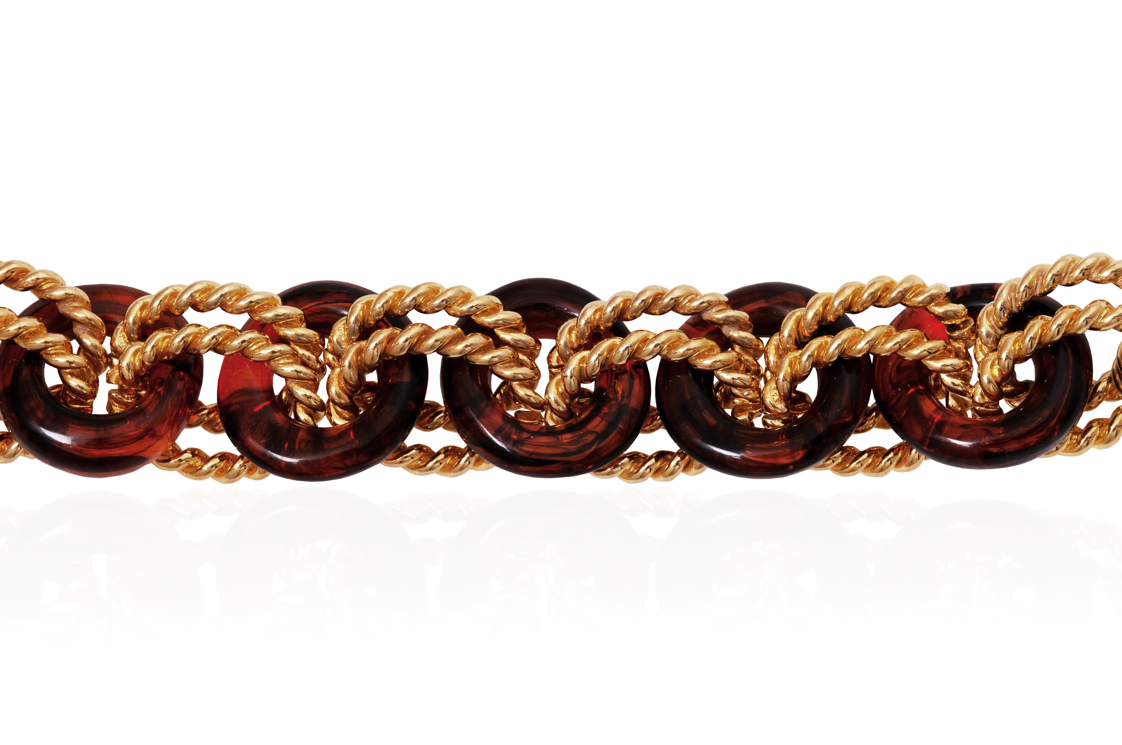 An extravagant toggle clasp bracelet from Kenneth Jay Lane, probably a late 1980s or early 1990s design. Featuring amber coloured acrylic resin and textured gold plated rings with his KJL signature on the toggle bar.  A chic choice for daytime or