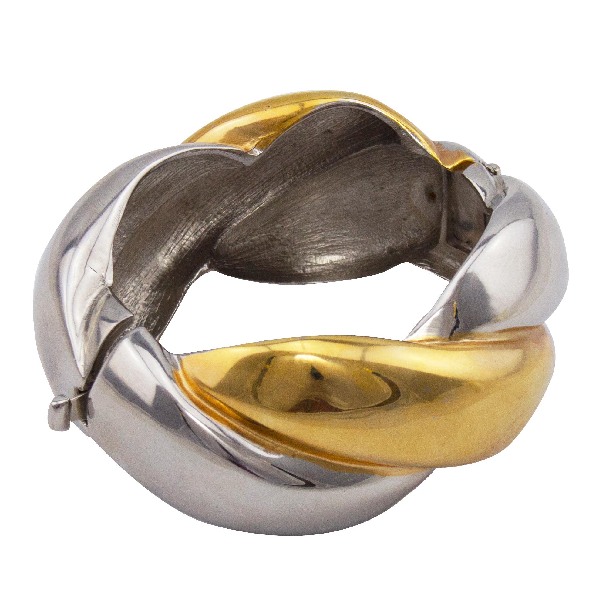 Absolutely fabulous and fun Kenneth Jay Lane bangle from the 1980s. A lovely mix of warm bright gold and cool silver tone metal braided together. Oval shaped with the opening on one side and the hinges on the other. Interior markings. A great piece
