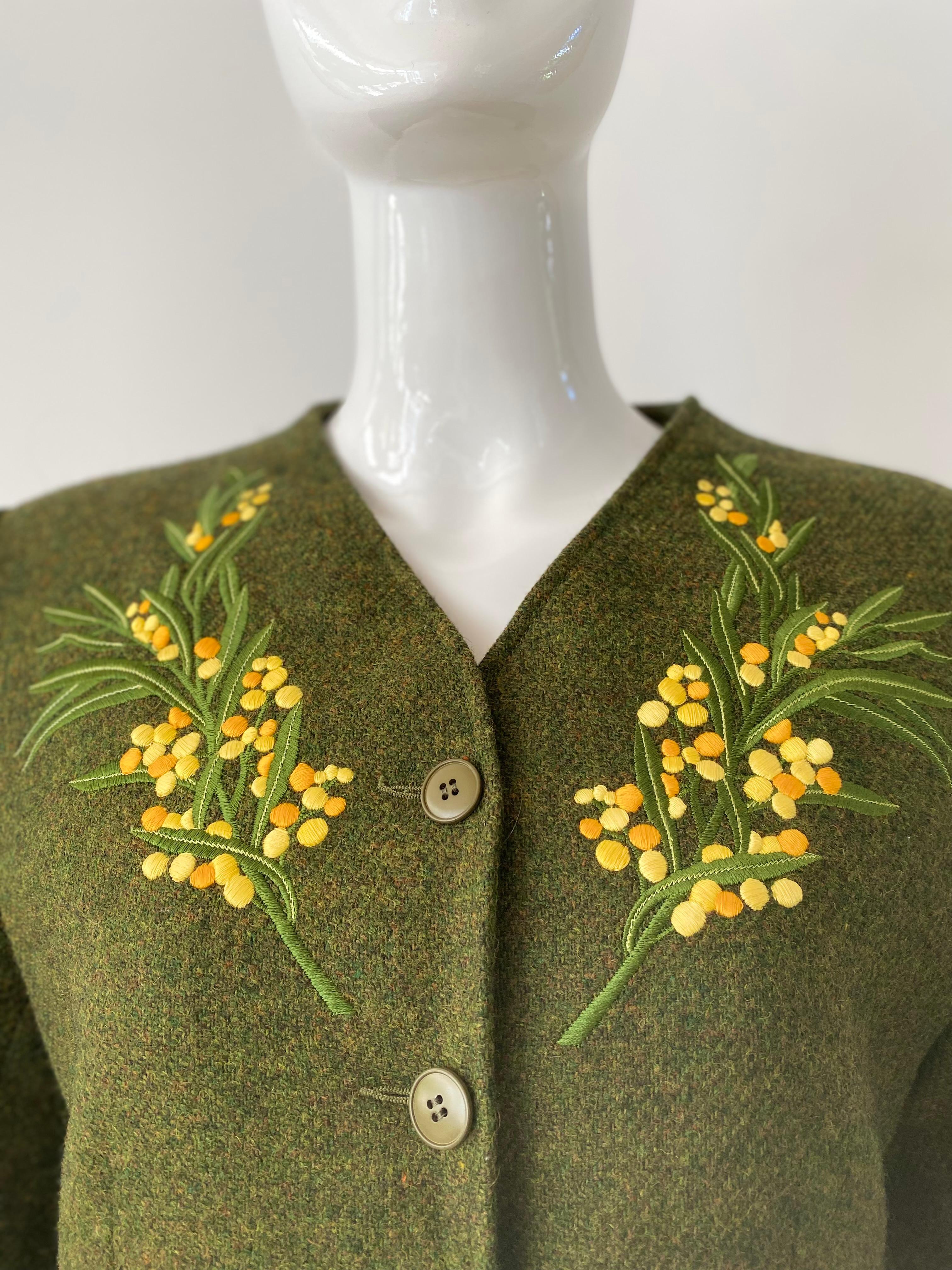 1980s Kenzo green wool blazer with yellow wheat flowers embroidered on either side of the chest. Collarless design and five button closure.  Outside pocket flaps on each hip and fully lined. Marked as a European size 36. 

Chest 34
