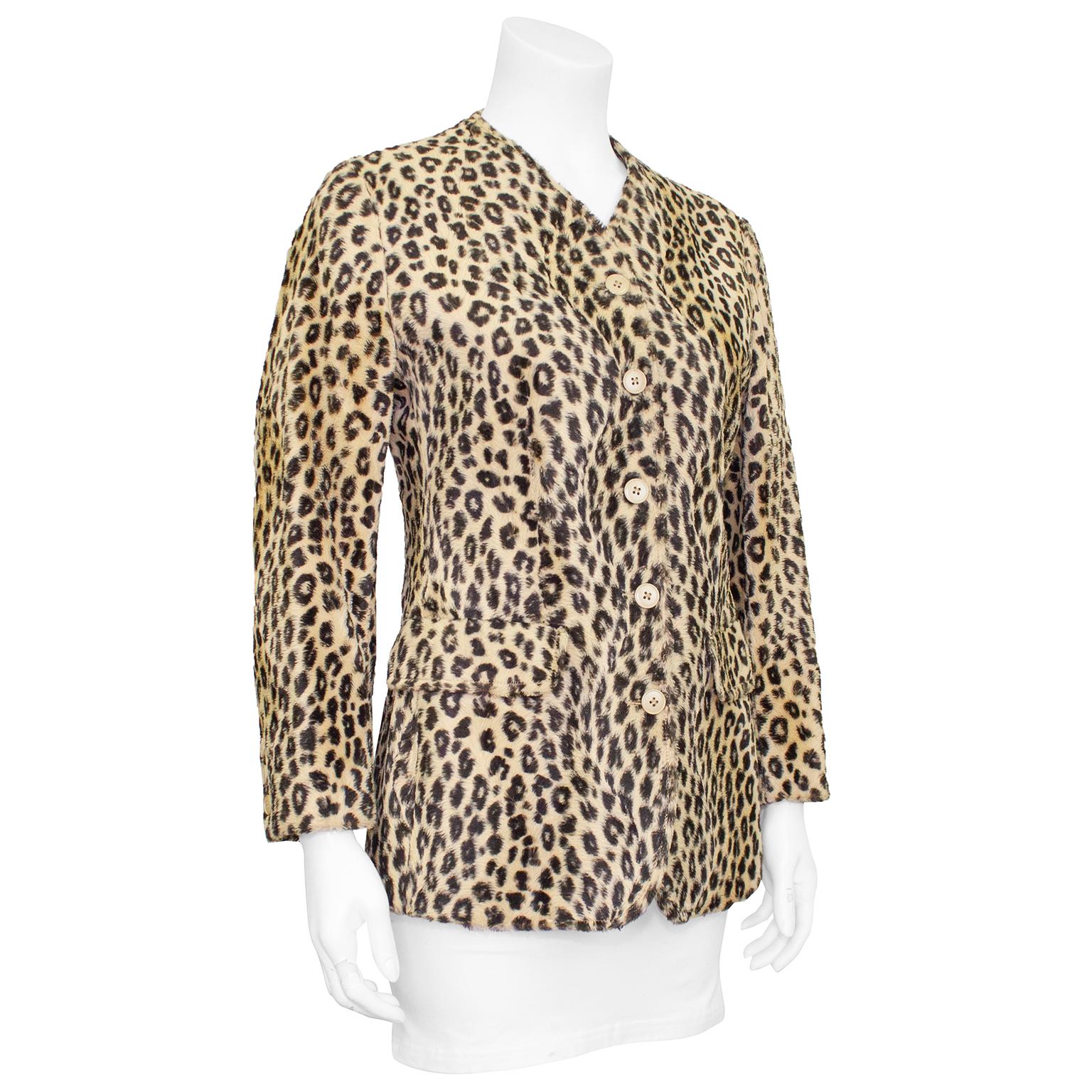 Beautiful Kenzo leopard faux fur jacket from the 1980s. Collarless with high v neckline, beige plastic buttons and flap pockets at hips. Champagne colored silk interior lining with extra button still attached. Excellent vintage condition. Purchased