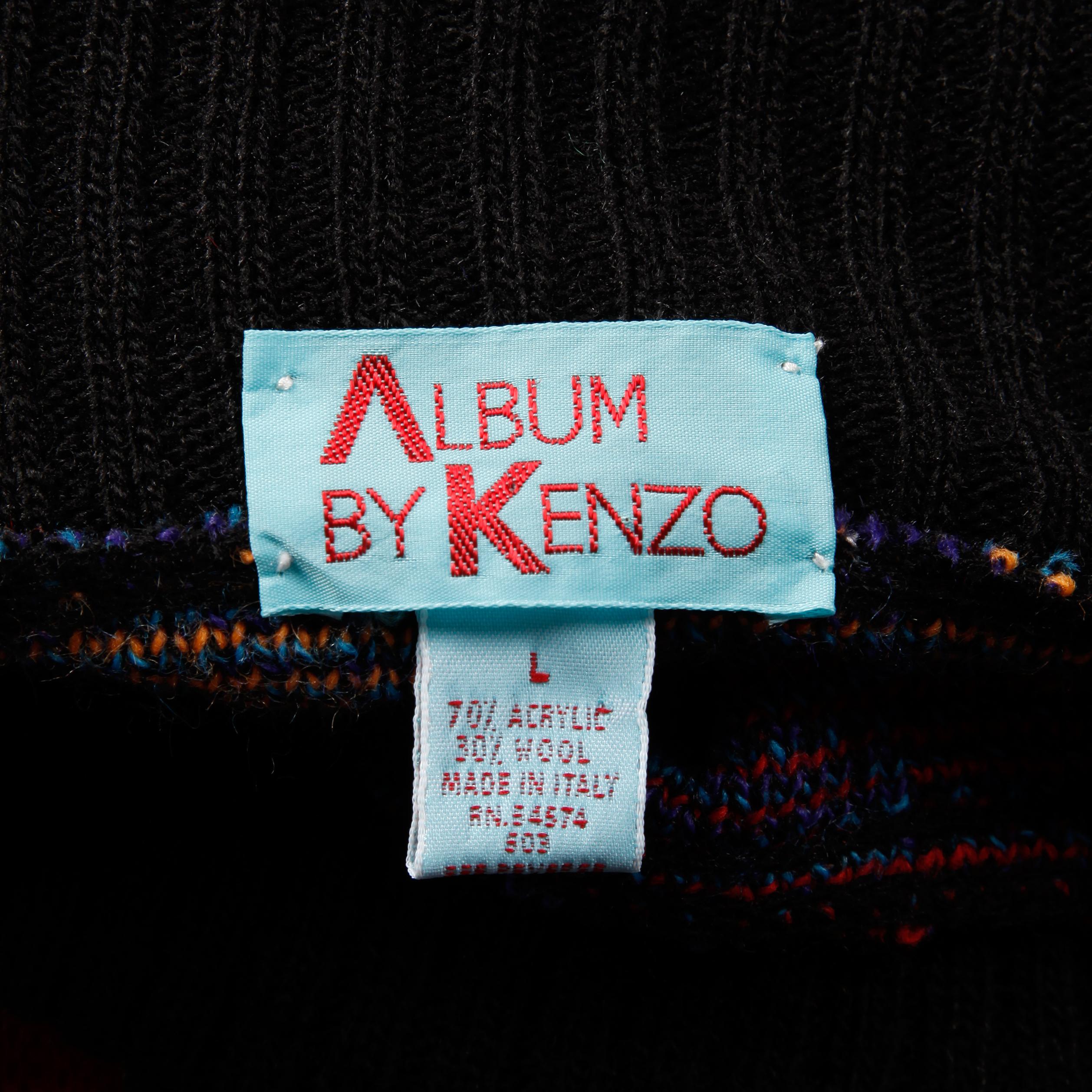 Vintage 1980s knit pullover sweater or jumper by Kenzo with colorful checkers and stripes. Unlined with no closure (pulls on over the head). The marked size is large. 70% acrylic, 30% wool. The bust measures 55