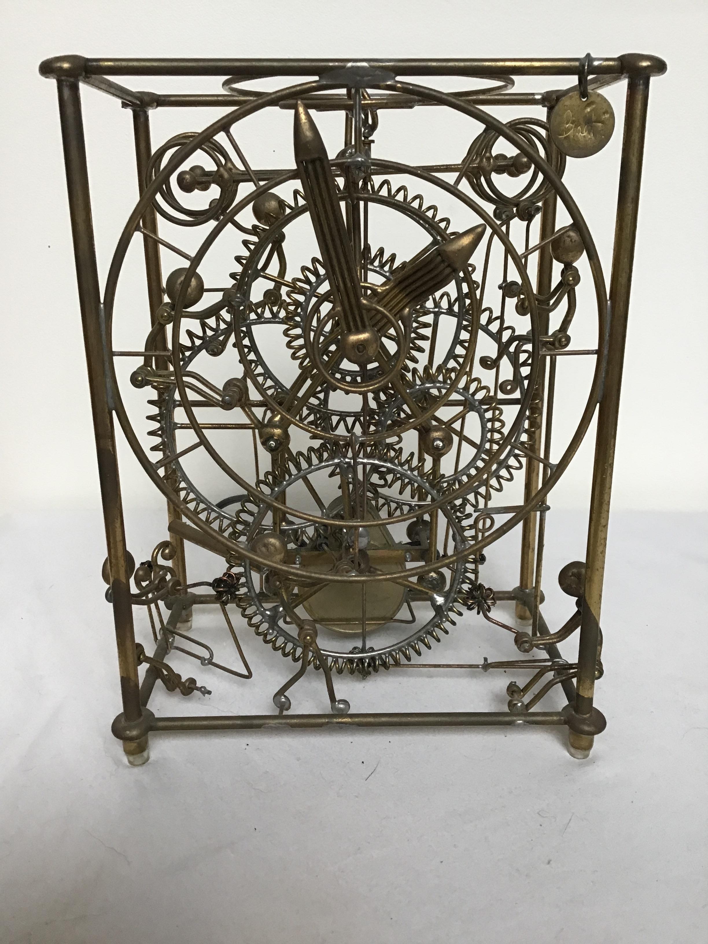 1980s brass Kinetico six man clock by Gordon Bradt. Each man magically moves as the clock tells time. Amazing!