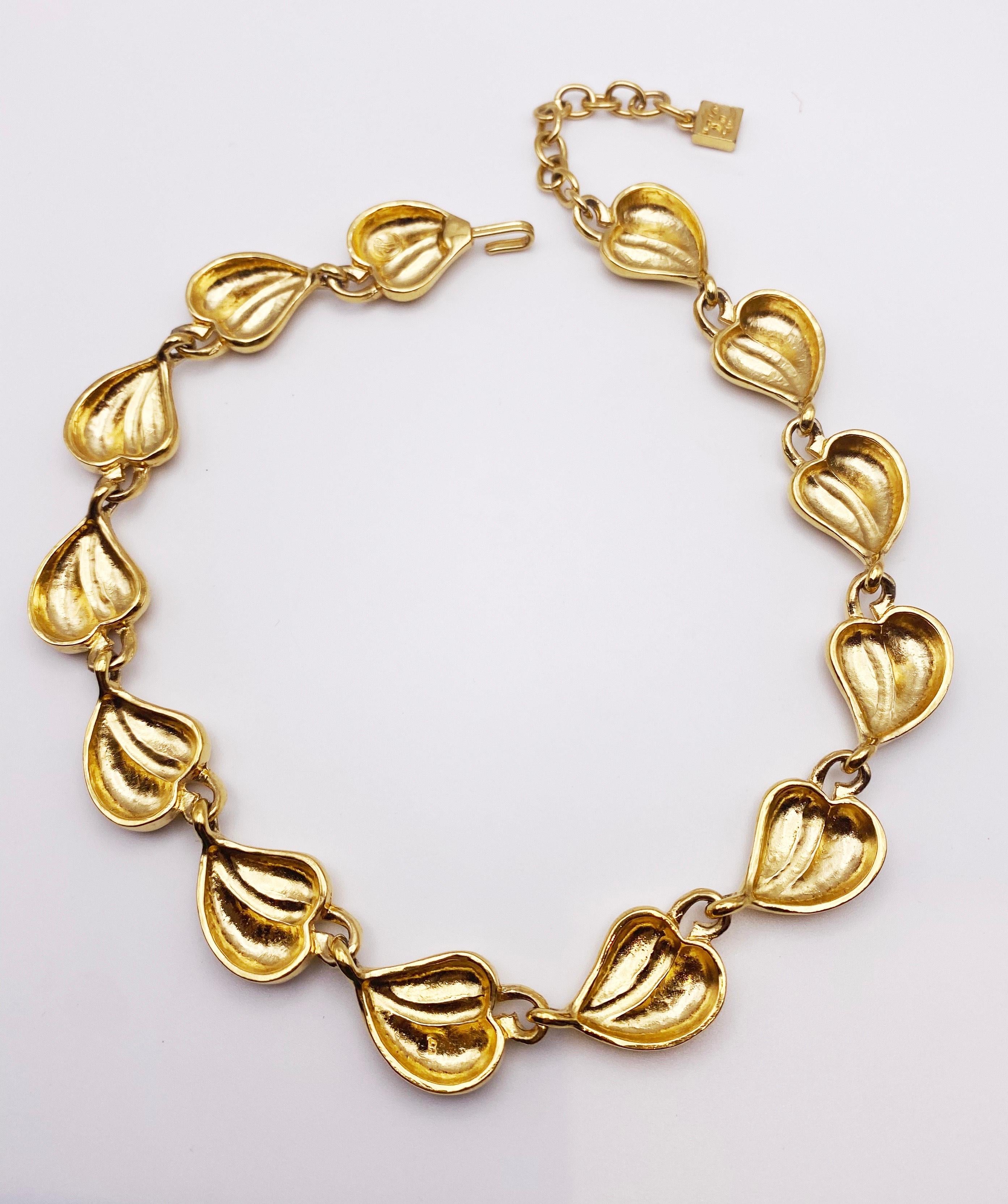 Stunning gilt necklace design by Karl Lagerfeld.  Stamped KL. Adjustable length. A beautiful piece to style with contemporary clothing trends. Good vintage condition. 