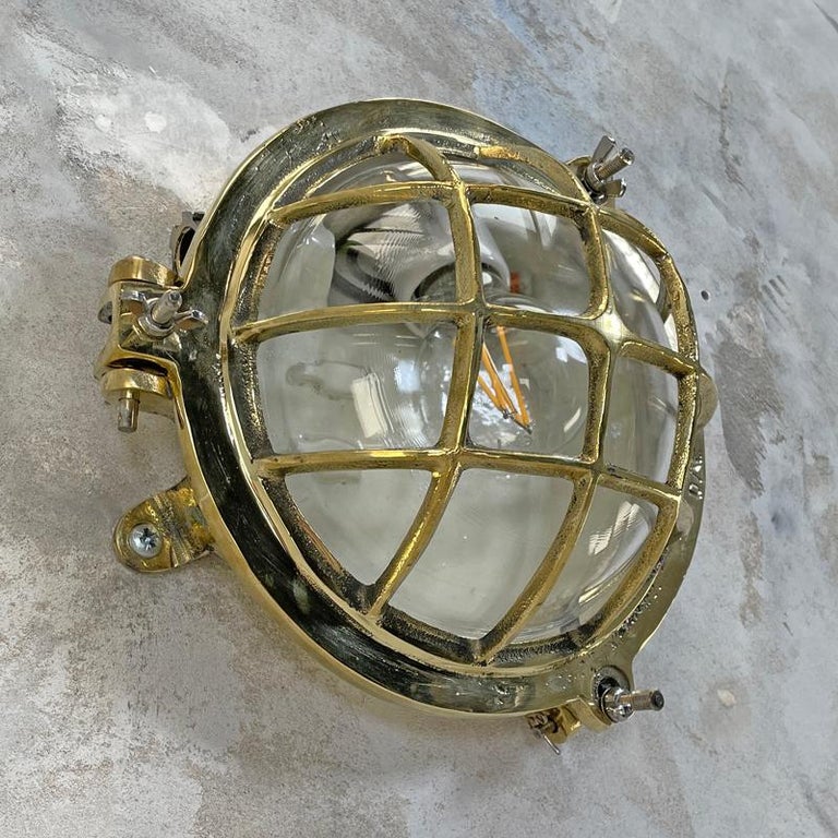 Industrial 1980's Korean Brass Circular Bulkhead Light with Cast Cage and Glass Shade For Sale