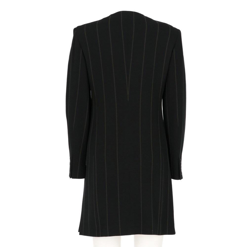 Krizia black pinstriped long jacket. Round neck with frontal buttoned closure, long sleeves and lateral slits.

Size: 42 IT 

Flat measurements
Lenght: 89 cm 
Bust: 43 cm 
Shoulders: 40 cm 
Sleeves: 57 cm

Notes: The item has a small hole on the