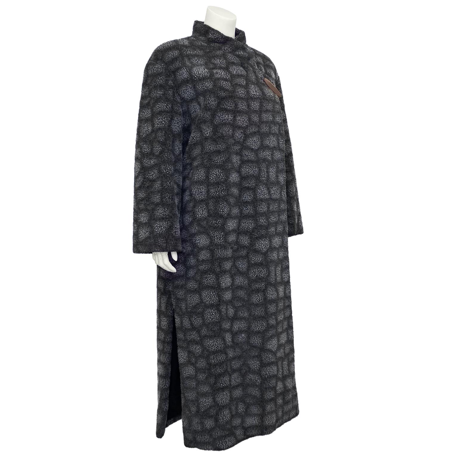 Krizia coat from the 1980s. Faux shearling with an all over dark and light grey crackle print. Wrap style that is secured by a single long oval wood button. Wrap style creates a standing tulip collar. Long slits at both side seams make it easy to