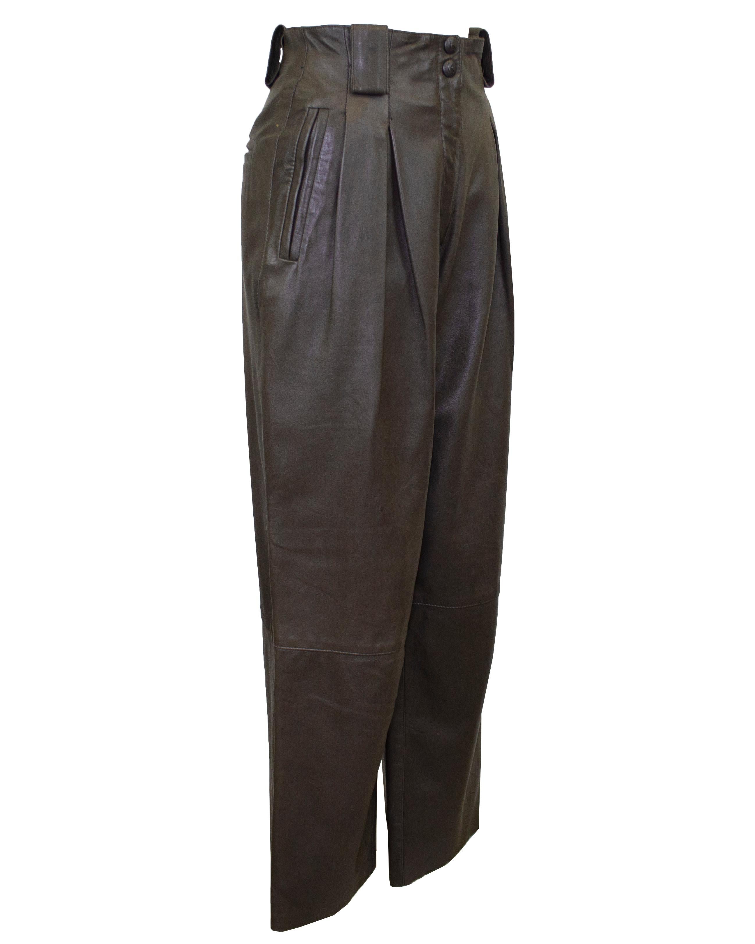 These Krizia leather pants from the 1980s are absolutely fabulous! Butter soft olive green with a great shape. They sit high on the waist with oversized belt loops, a zipper and snap fly. The leg is slightly wide with inverted pleats at the hips and