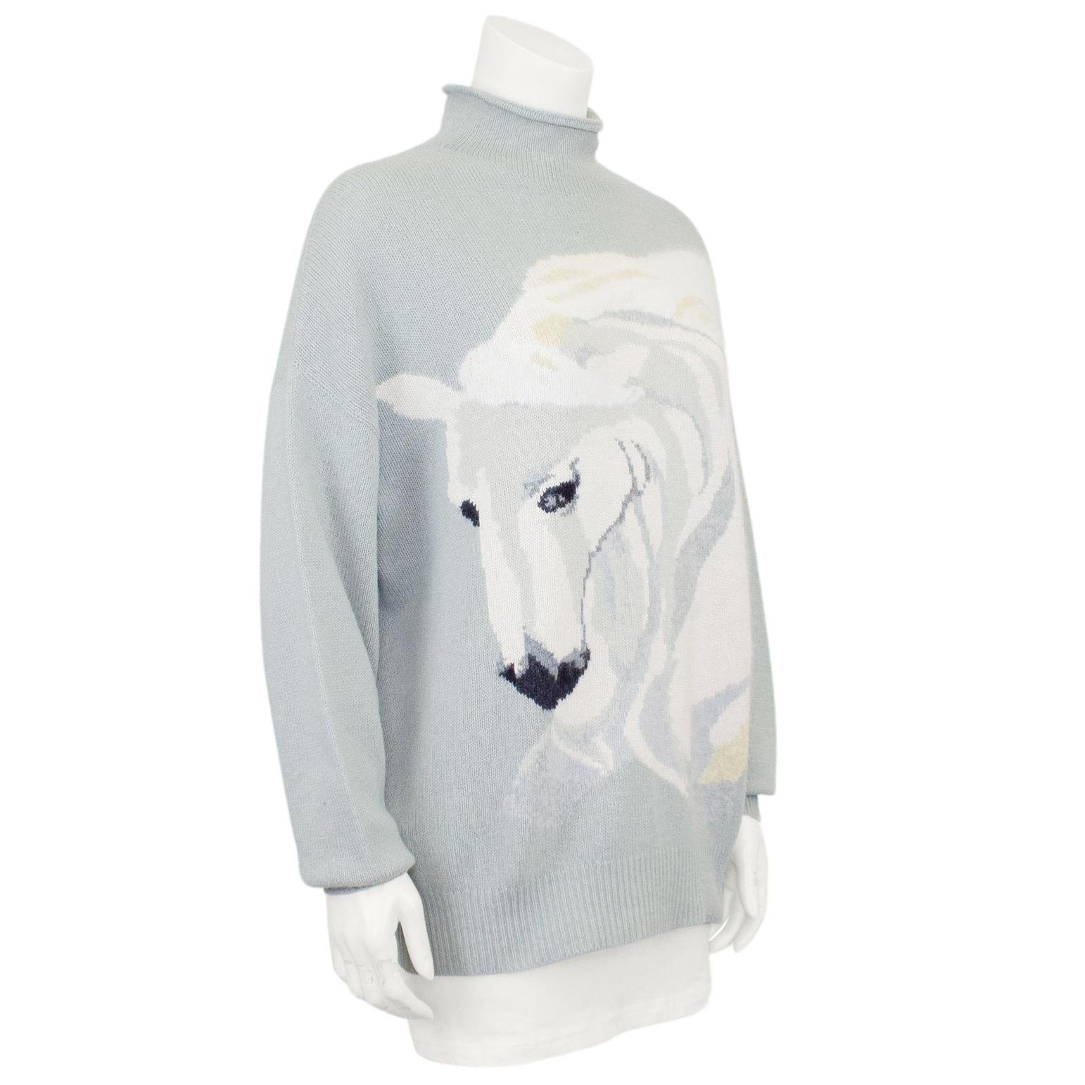 Known for their incredible knits featuring animals, this sweater is the ultimate 1980s Krizia piece. Oversized pale blue wool roll neck sweater with a large and majestic white horse head graphic. Dropped shoulder, dolman sleeves and ribbed cuffs and