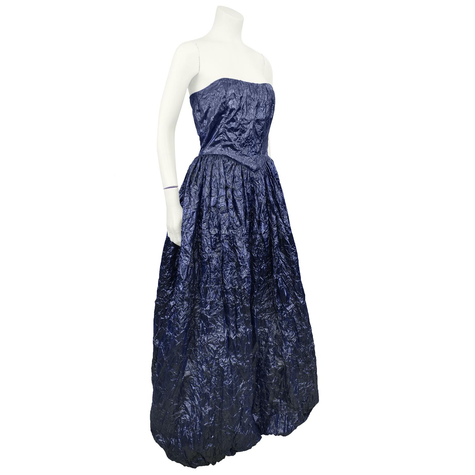Very unique Krizia strapless gown from the 1980s made for Chez Catherine. The dark navy lurex and nylon blend fabric has a treated crinkle texture resembling a trash bag. The dress is princess style with a bubble hem and dipped V corset waist. Zips