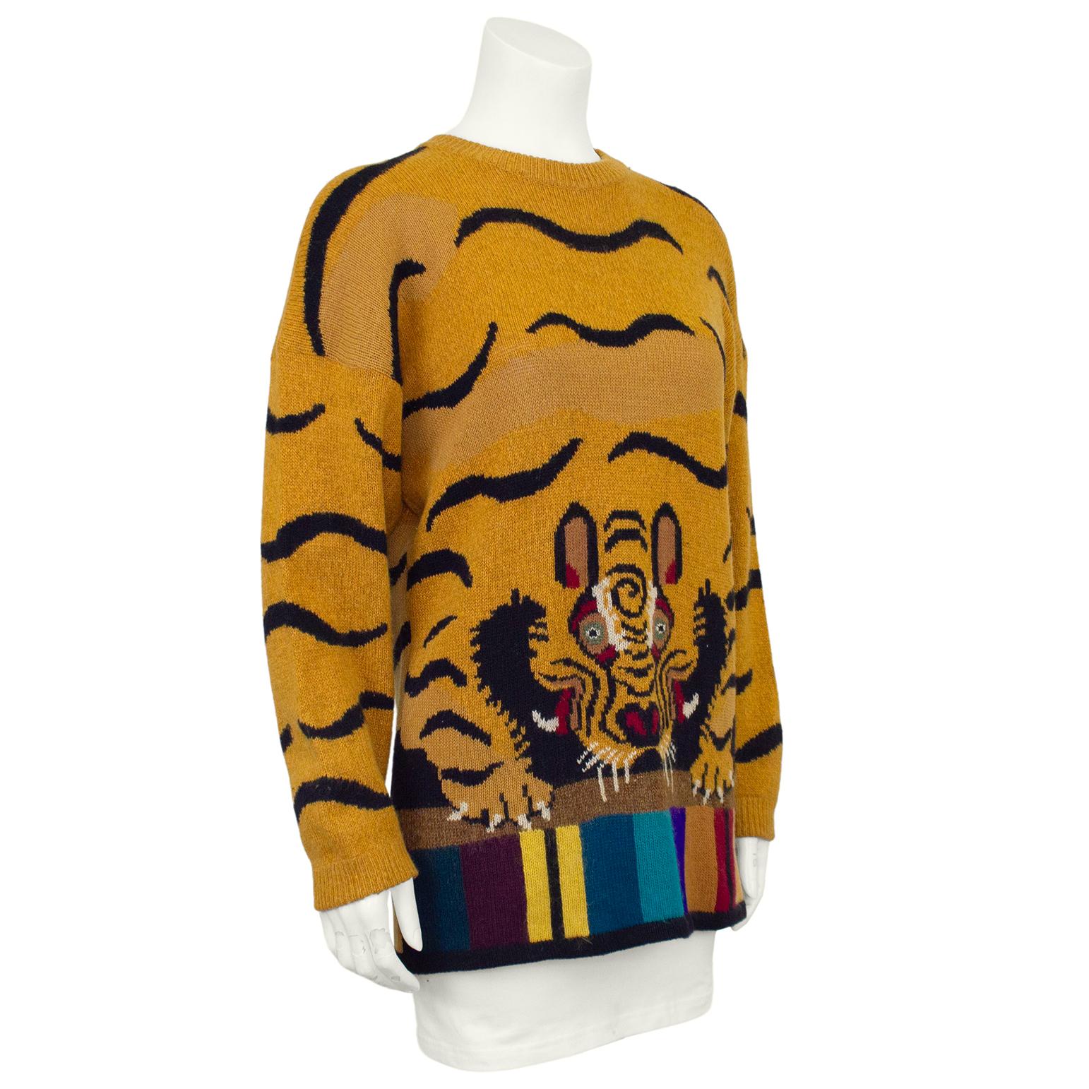 Known for their incredible knits featuring animals, this sweater is the ultimate 1980s Krizia piece. Oversized tan and black tiger print sweater with detailed tiger face and a striped multicolour hem. Ribbed neckline and cuffs, loose hem. Dropped