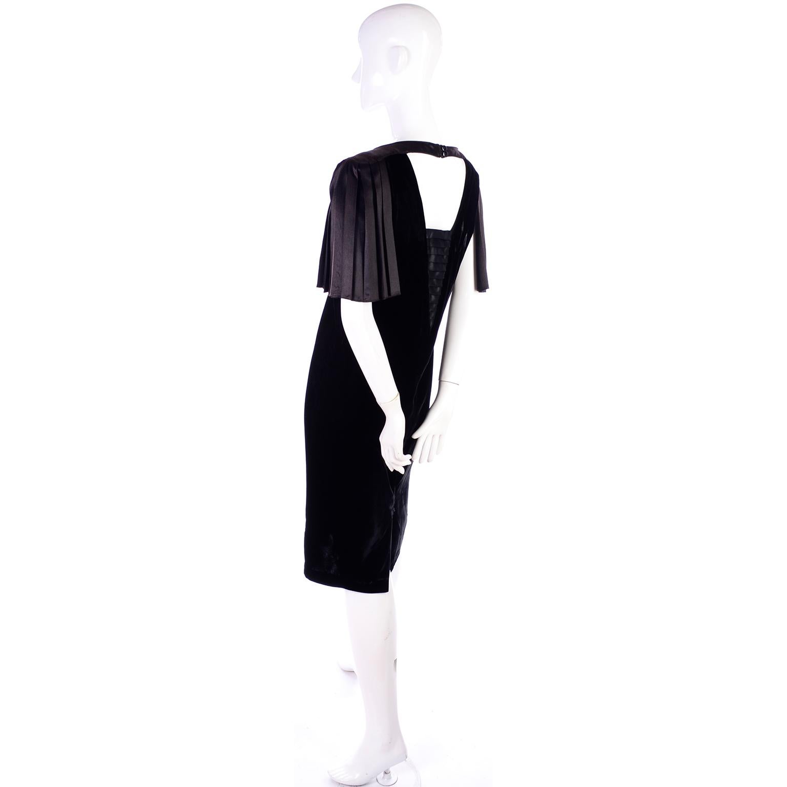Gorgeous vintage 1980's black velvet dress with satin pleated sleeves and satin trim! It has satin shoulders that lead to pleated sleeves that are only attached at the shoulder! The back closes with a button on a satin strip at the top, but is a