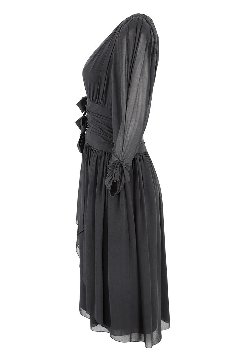 This gorgeous 1980s back silk chiffon dress is by celebrated Paris fashion house Lanvin and is a timeless piece in brilliant vintage condition. The thick silk chiffon fabric is arranged in a series of soft pleats and gathers to create a simple