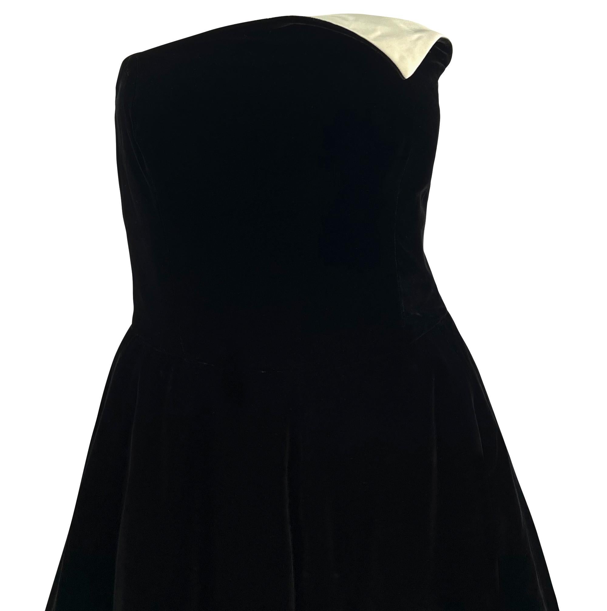 This fabulous black and ivory Lanvin gown from the 1980s is crafted from rich black velvet with an ivory silk satin lining that elegantly contrasts the skirt. The top of the dress features a folded-over detail that seamlessly incorporates the ivory