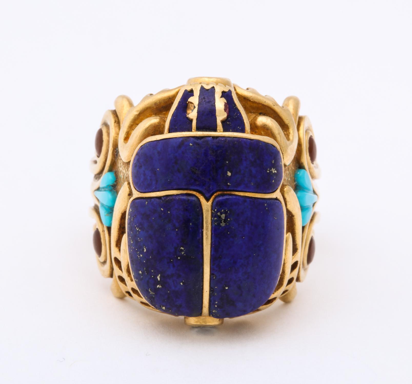 One Handmade Unisex Ring In Form Of A Figural Scarab Secada. Ring Is Embellished With A Lapis Lazuli Stone For Its Body And With Four Cabochon Citrine Stones. Ring Is Flanked By Teo Fan Shaped Carved Turquoises. Secada Ring Is Also Designed With Two