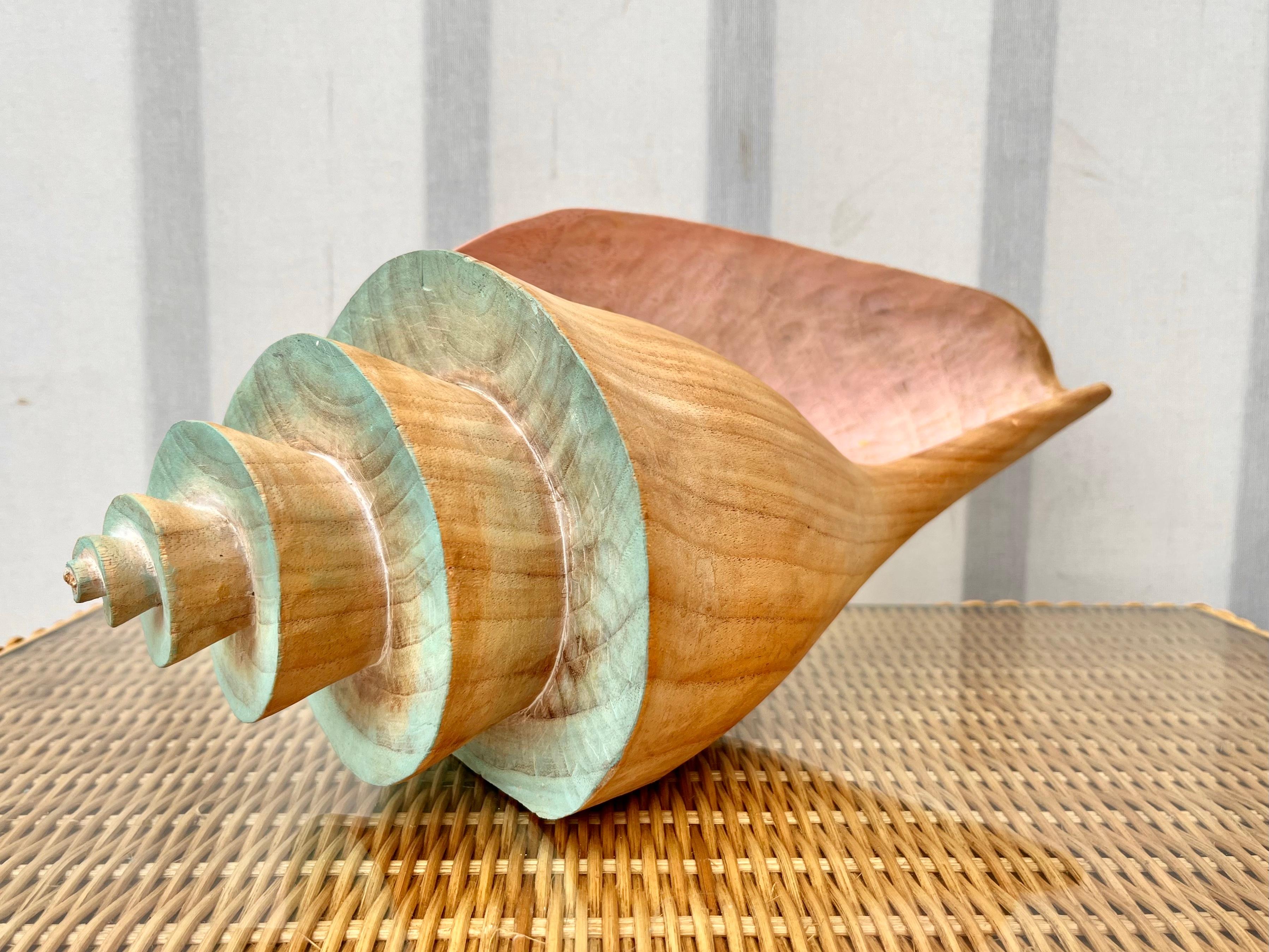 Large Late 20th Century Coastal Style Carved Wood Queen Conch Seashell Sculpture. Circa 1980s 
Carved out of one solid piece of wood, this large queen conch shell figurine features a tropical Inspired design accentuated with teal and pink pastels