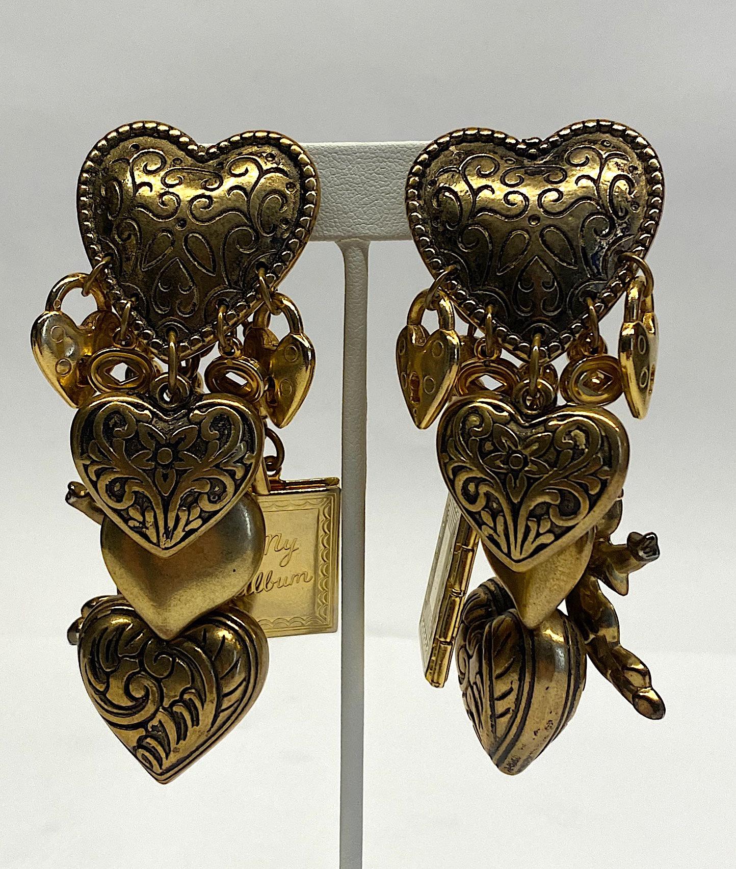 A fabulous example of 1980s big and chunky style vintage fashion earrings in polished satin gold and antique gold finish with black enamel high highlights. Each earring hangs approximately 2 inches wide and 4 inches long and is comprised of a single