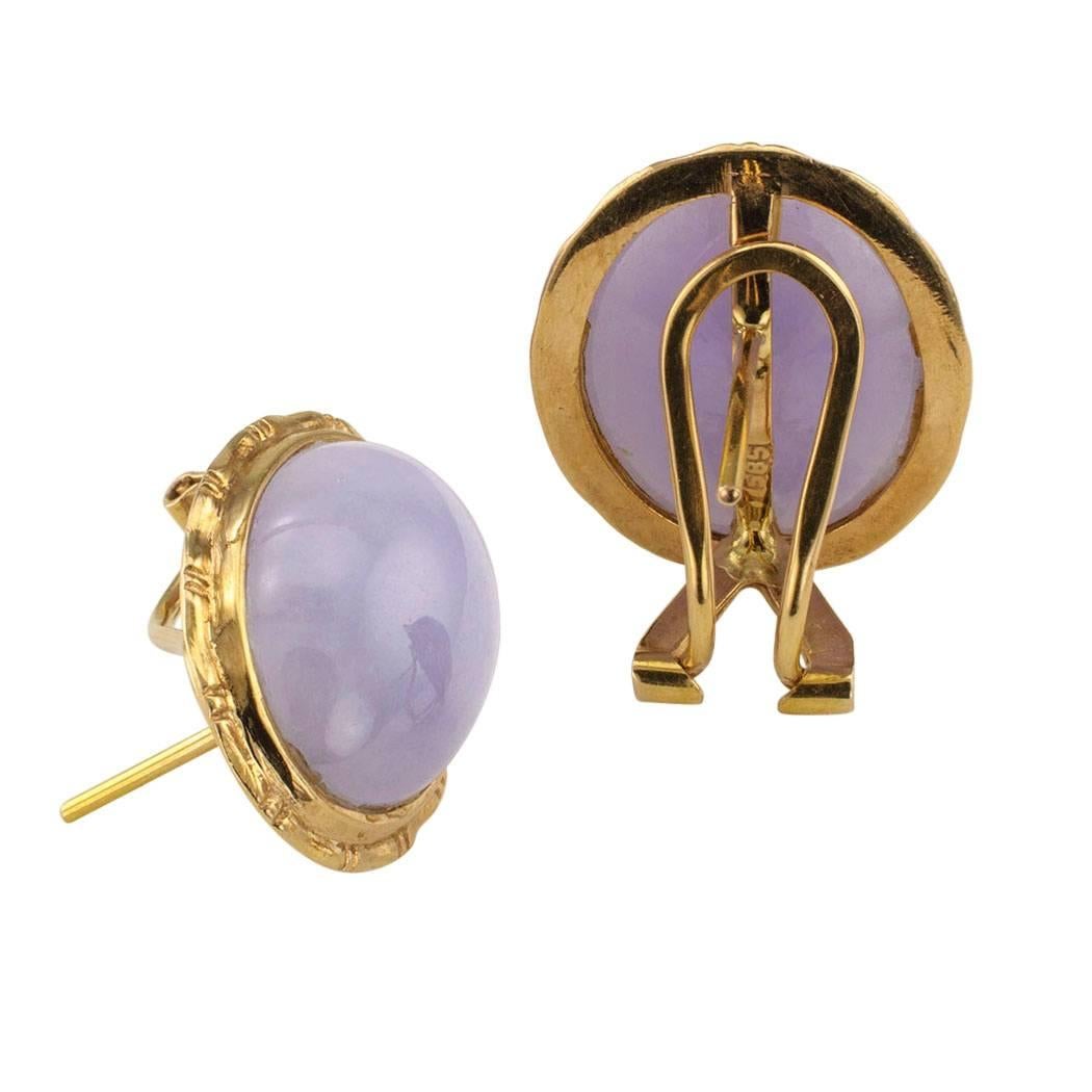 Estate 1980s lavender jade and gold earrings. Featuring a pair of well-matched lavender jade cabochons, set in simple 14-karat yellow gold bezels, the backs fitted with omega and post clips. These fashionable earrings are neither too large; nor too
