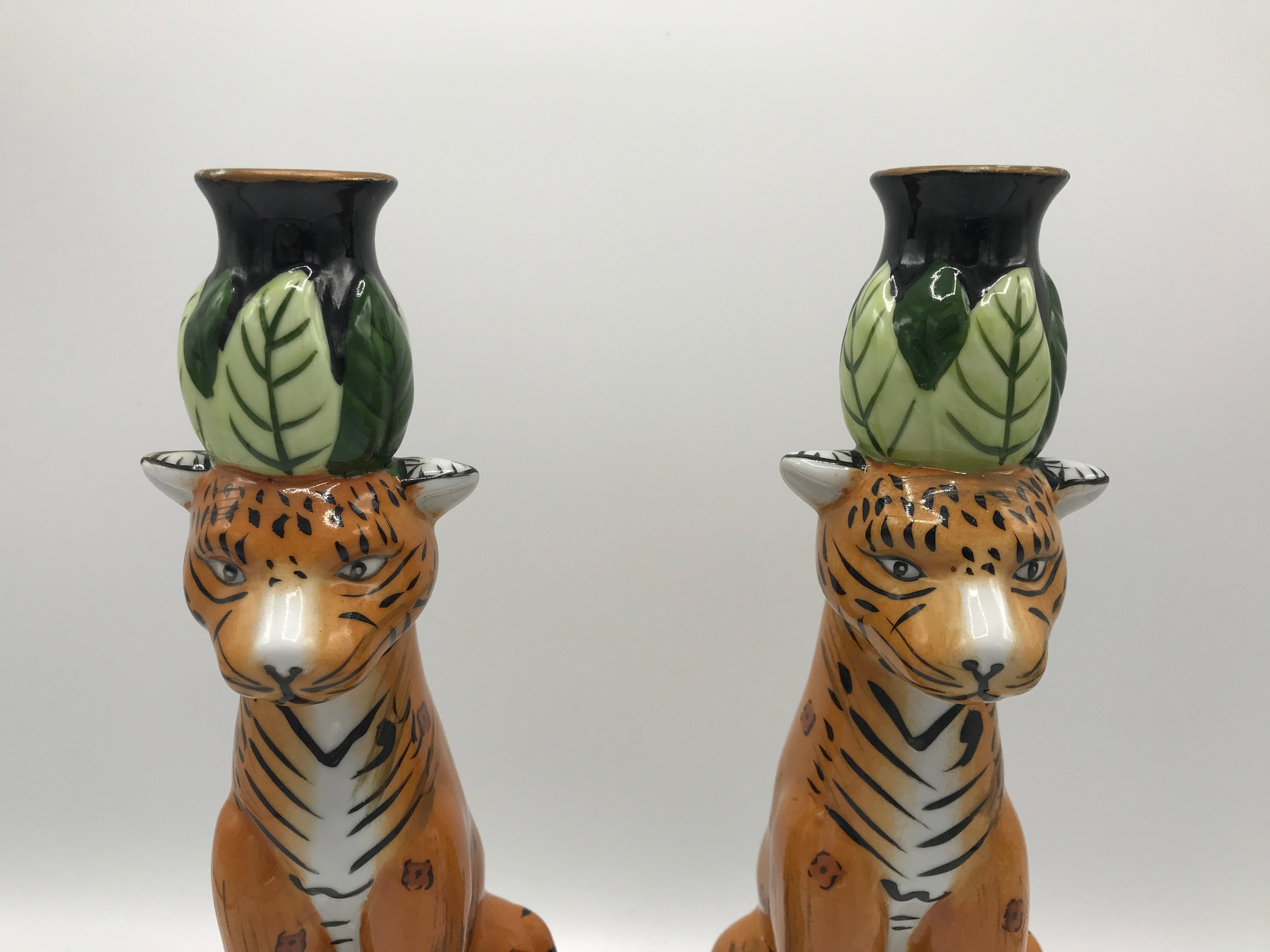 Offered is a fabulous, pair of 1980s painted porcelain candlestick holders. The pair has a beautiful, perched leopard sculpture with the candleholder above its head. Heavy, 3.5lbs for the pair.