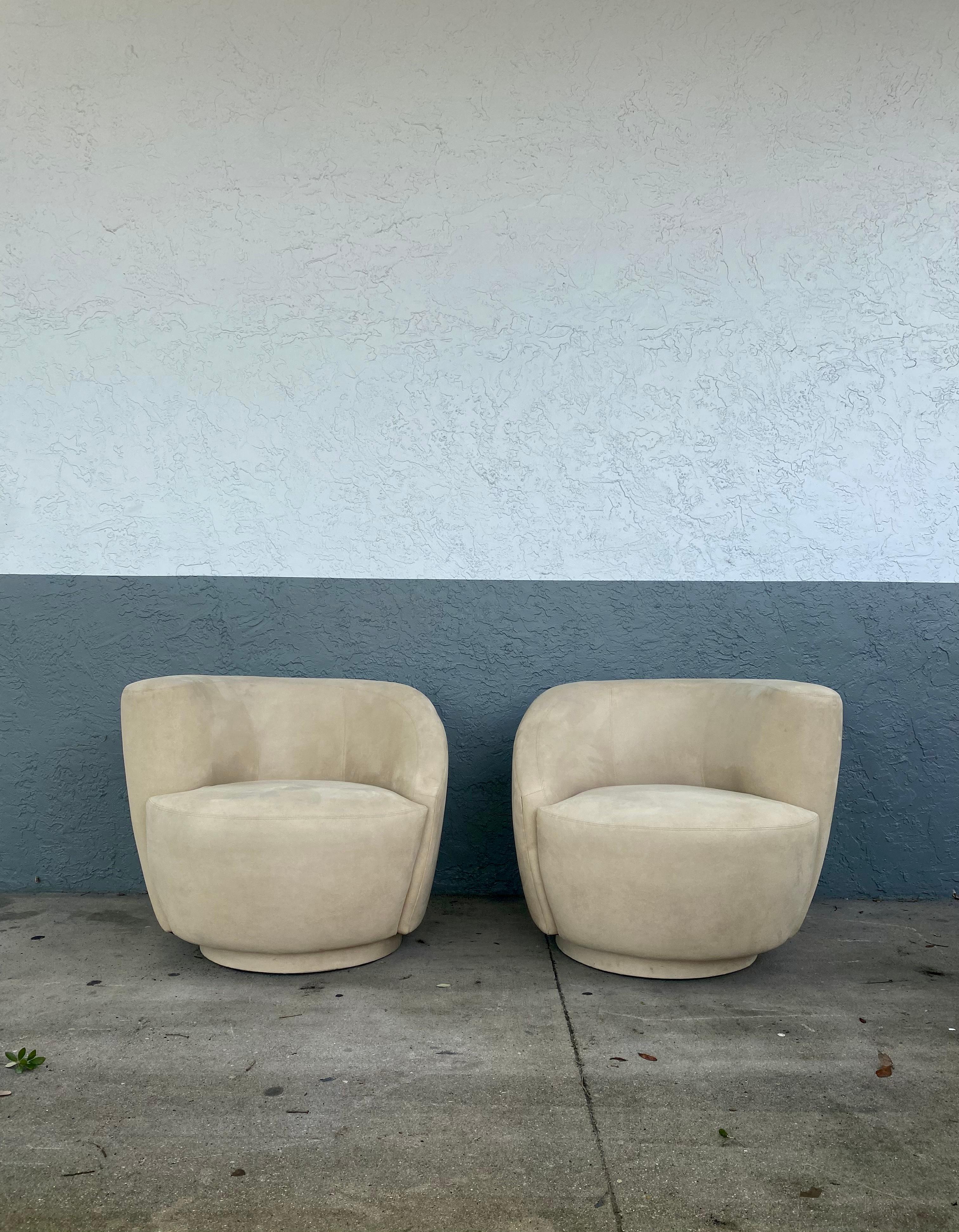 These Iconic swivel chairs are packed with personality! Outstanding design is exhibited throughout the monumental form. Post modern designed by Vladimir Kagan. The unique corkscrew shape in original light beige alcantara suede upholstery also