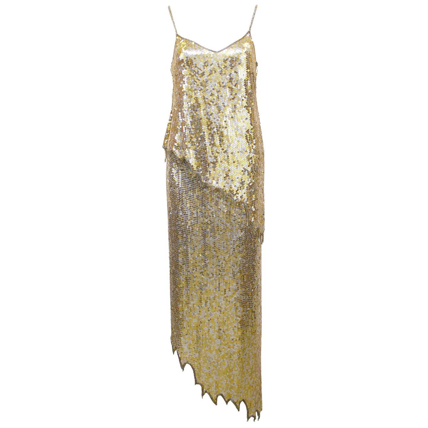 Glitzy 1980s Lillie Rubin top and skirt ensemble. Allover gold and silver sequins with small gold and silver beaded trim and straps. Top features spaghetti straps, v neckline and asymmetrical scalloped hem. Skirt is high waisted, straight and a