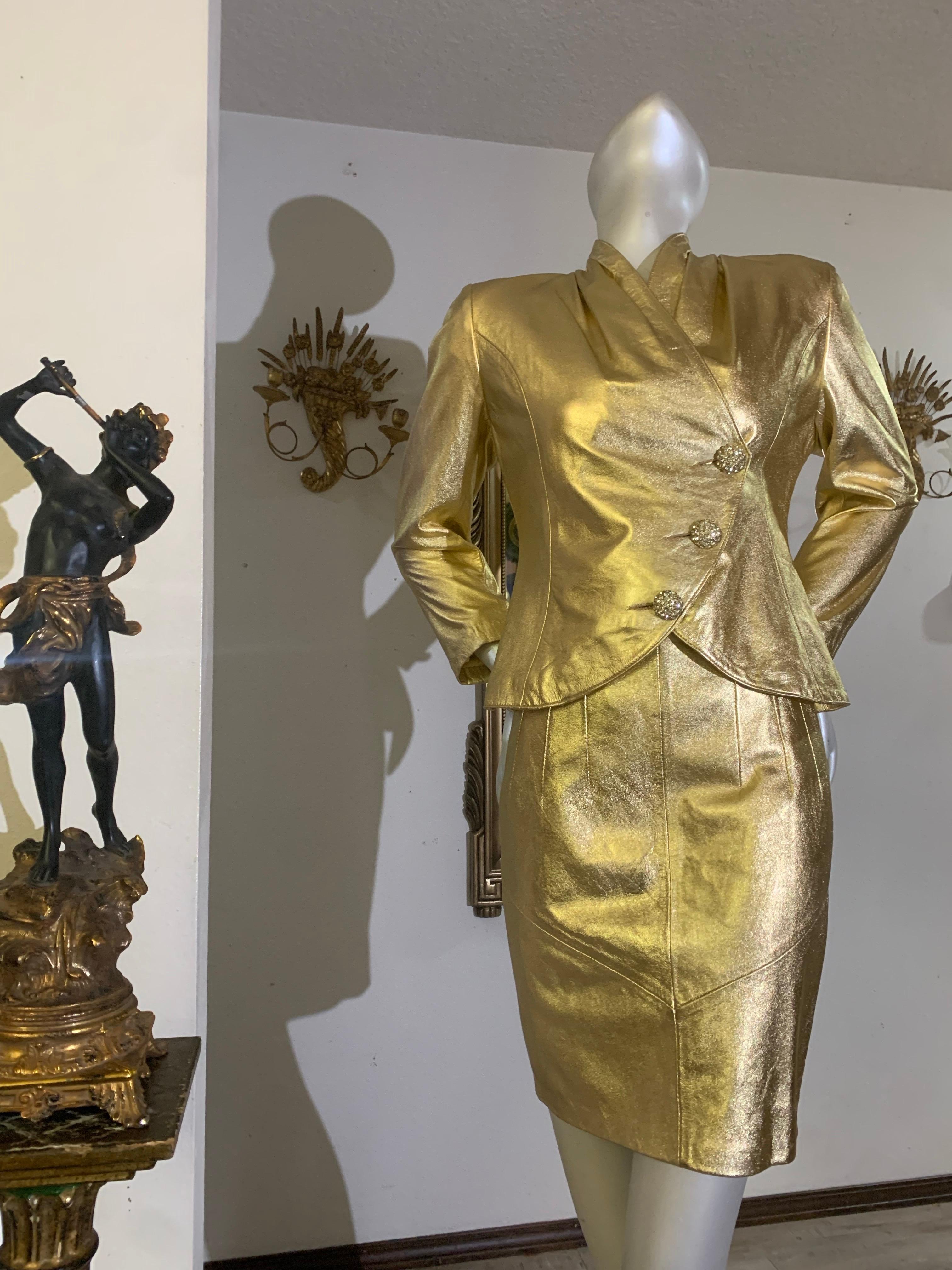 1980s Lillie Rubin Gold Metallic Leather Tailored Skirt Suit w Rhinestone Buttons:  The softest lambskin is molded into a 1950's-inspired form-fitting silhouette skirt suit with  softly draped neckline, and curved hemline accented with angled