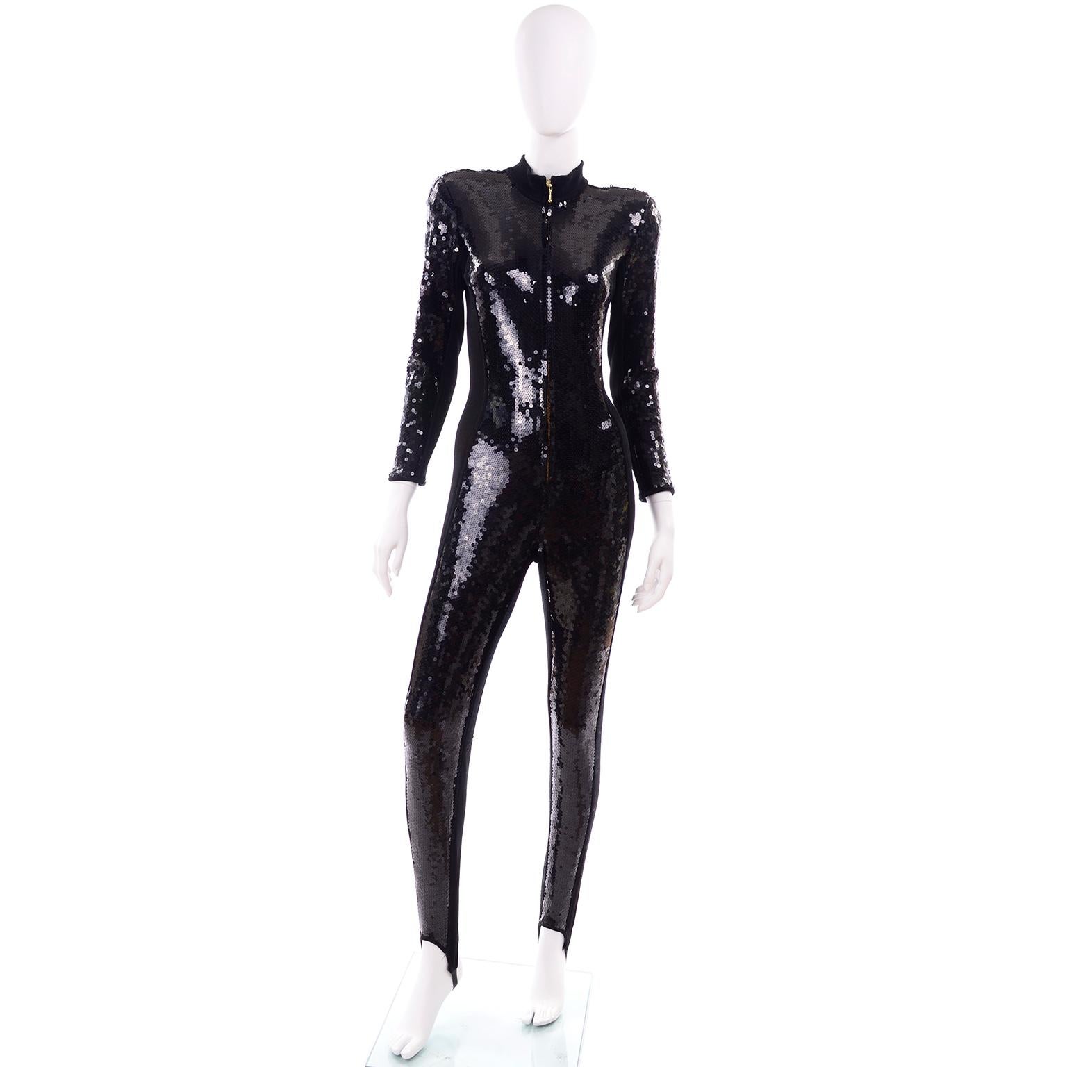 This is an absolutely stunning vintage zip front black sequin jumpsuit from Lillie Rubin. This 1980's  stretch jumpsuit contours to the shape of the body and the shoulder pads and fitted waist make it an extremely flattering fit.  We love the