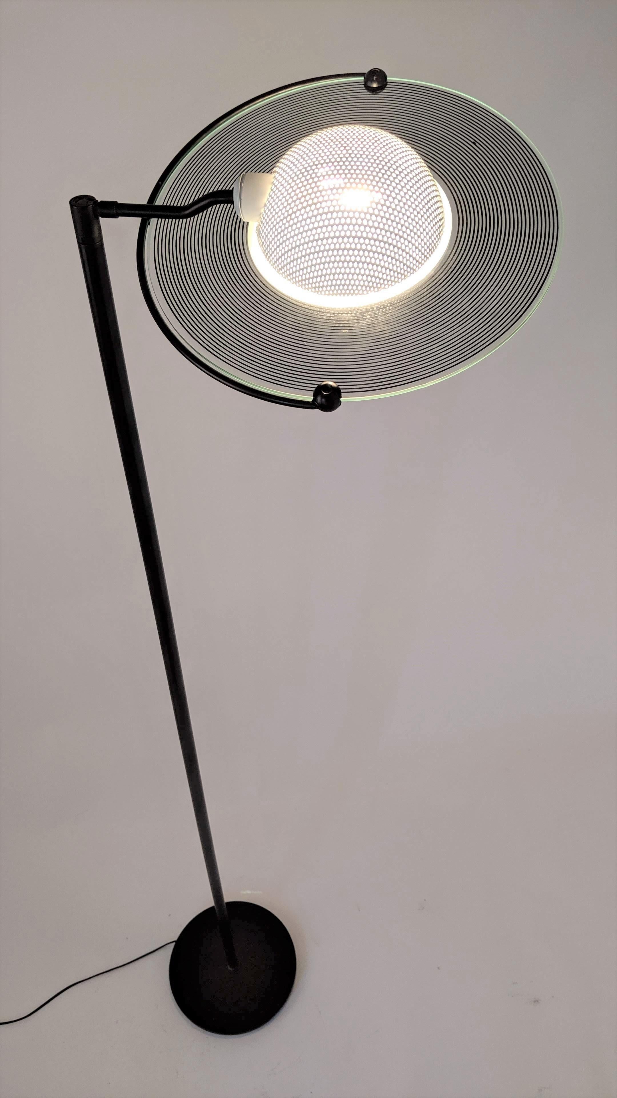 Italian halogen floor lamp made with prime quality material.

Well made solid construction.

Opale convex glass shade with black stripes printed in clear glass to create multiple ring effect. 

Enameled pierced convex metal hardware under