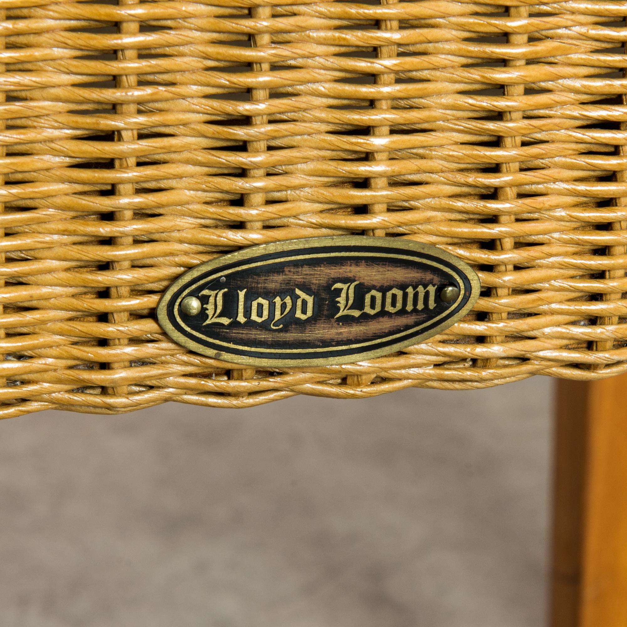 This set of eight dining chairs with tapered legs and full backs was made in the United Kingdom, circa 1980. They are manufactured by Lloyd Loom, which developed an innovative technique of twisting kraft paper around steel wires. Woven sheets of the