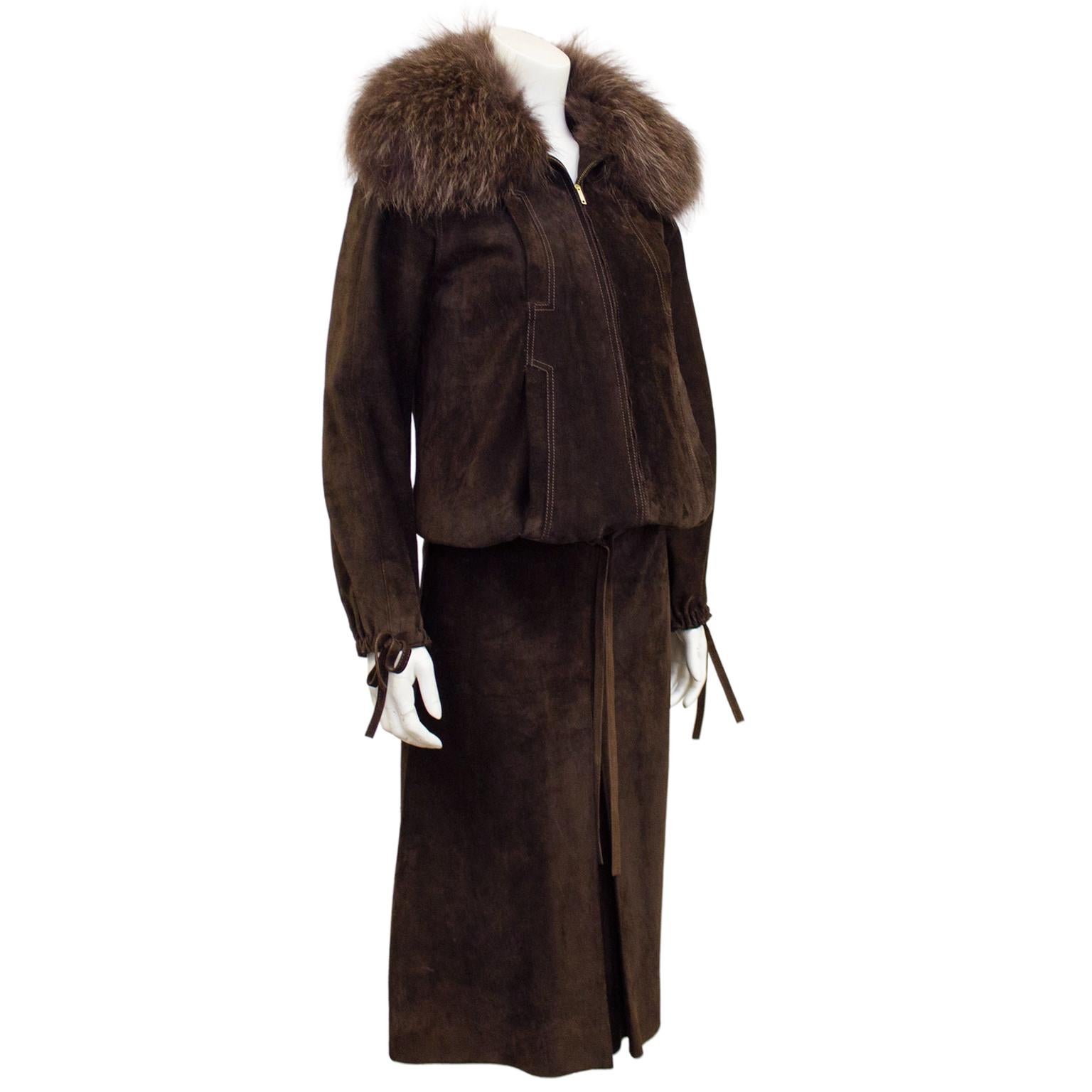 Stunning Loewe ensemble dating from the early 1980s. Brown suede oversized bomber jacket with tonal top stitching details and zipper front. Elastic cuffs and waist with ties. Four vertical slit pockets at waist and bust. Oversized brown fox collar.