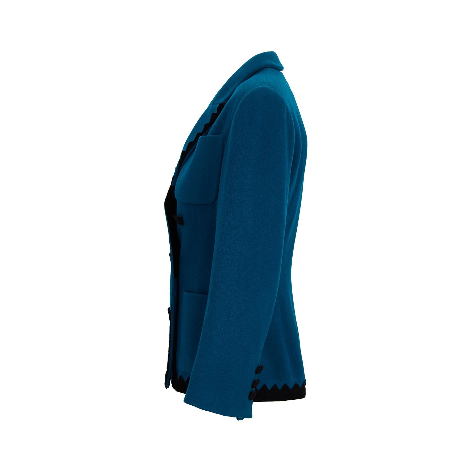 This late 1980s or early 1990s teal wool and black jacket is a really early piece from Lolita Lempicka; a striking double breasted design with suedette 'crocodile teeth' trimming the edges of the jacket and the lapels.  There are three patch