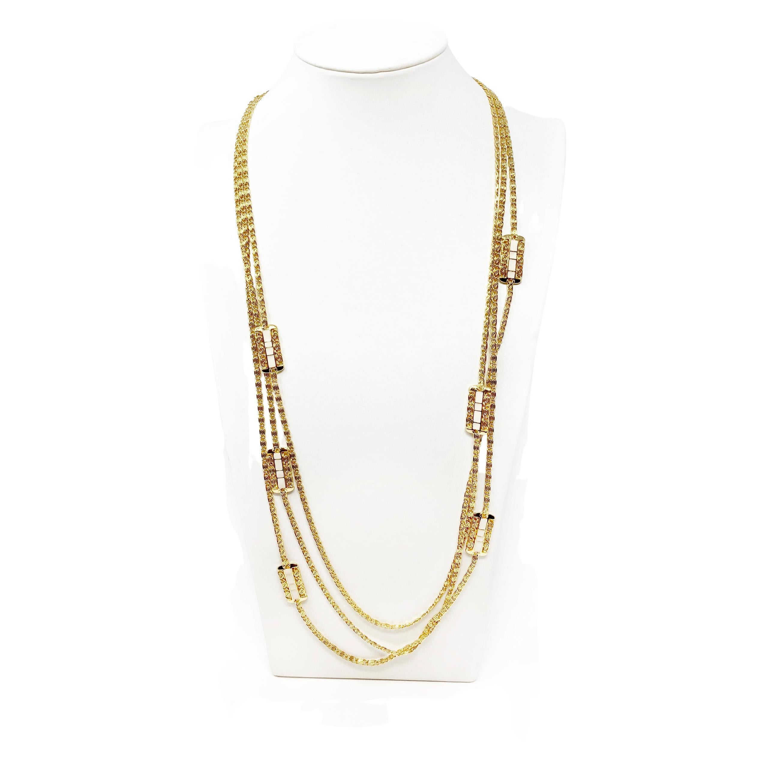 Mint 1980’s Balenciaga triple gold-tone chain- and ivory enameled necklace.  
The three Gold chains are at varying lengths to give a classic layered look. Multiple enameled panels throughout  the necklace. A very timeless look to add to your