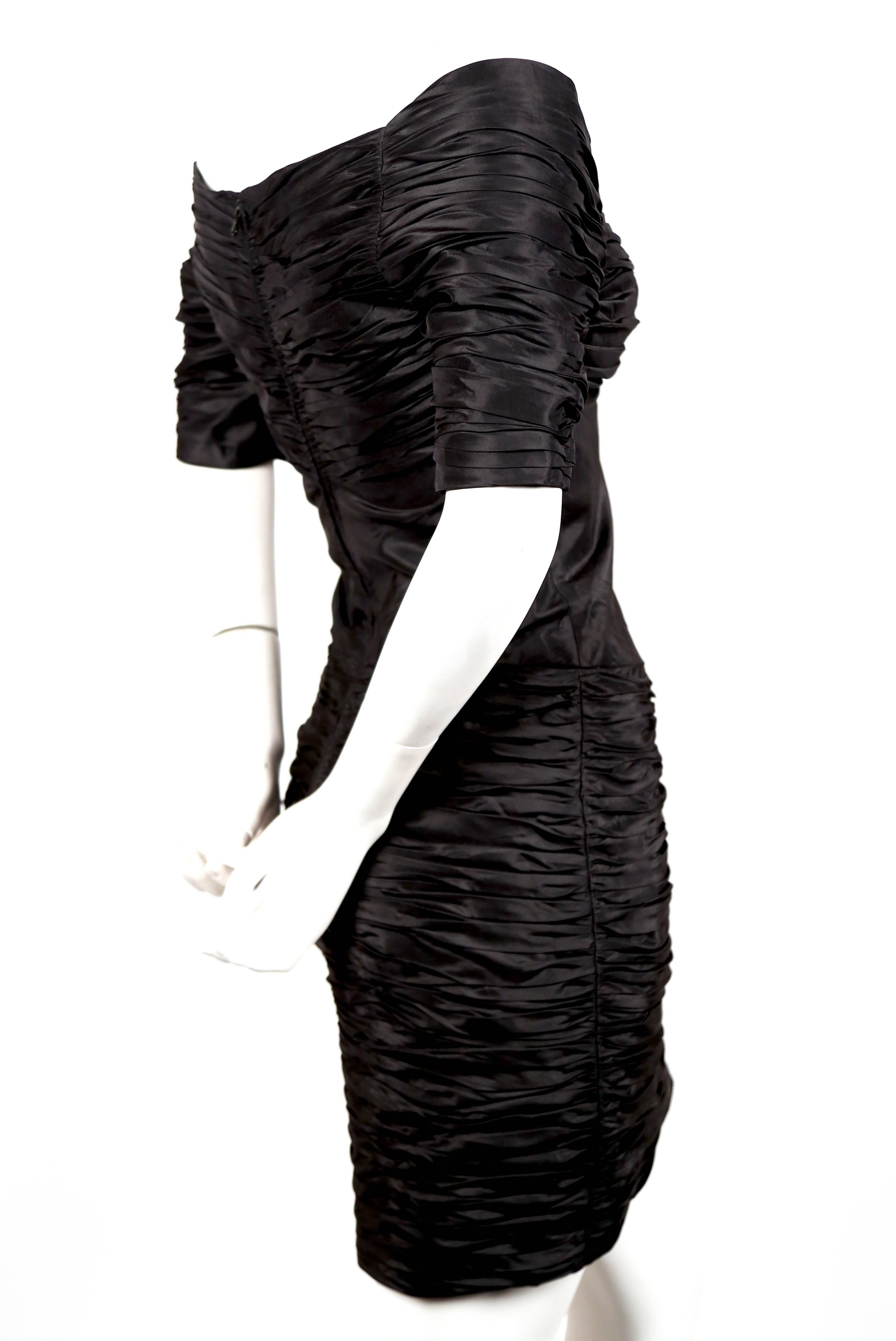 Jet-black, ruched dress designed by Loris Azzaro dating to the early 1980's. Dress best fits a US size 2 (32