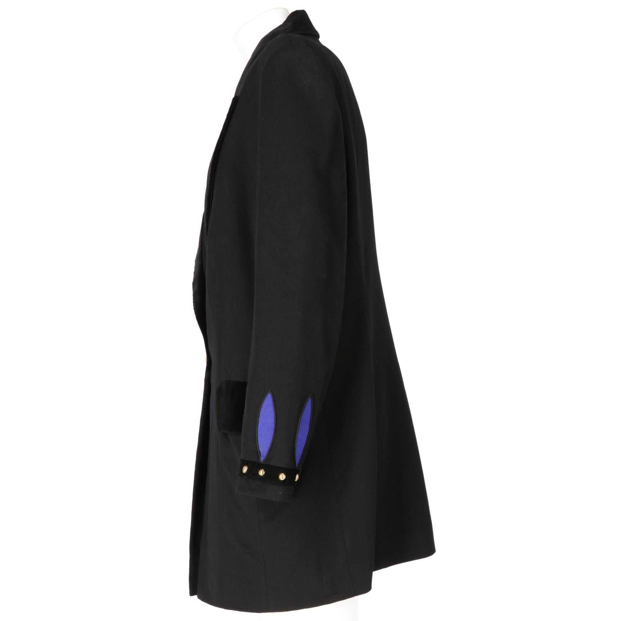 Louis Féraud black blazer in wool and angora blend, with classic velvet spear collar, long sleeves with embroidered blue details and velvet strip with golden metal studs, front closure with jewel button and two pockets with velvet flap. Lining with