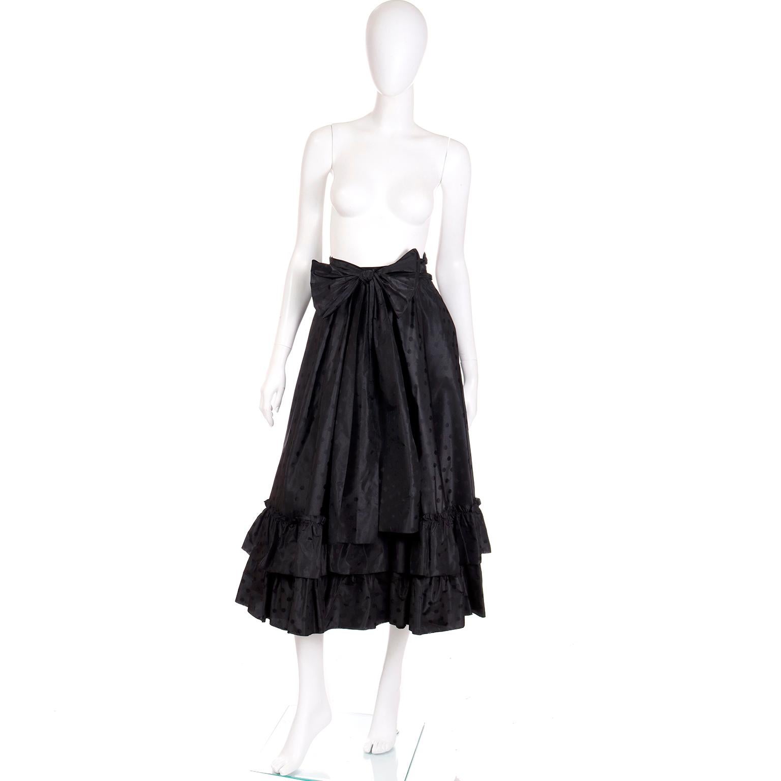 This is a dramatic vintage Louis Feraud black tonal polka dot silk taffeta full skirt with a double tier of ruffles at the bottom. We love the volume in this skirt and it can be worn with so many different kinds of tops! The skirt has a matching
